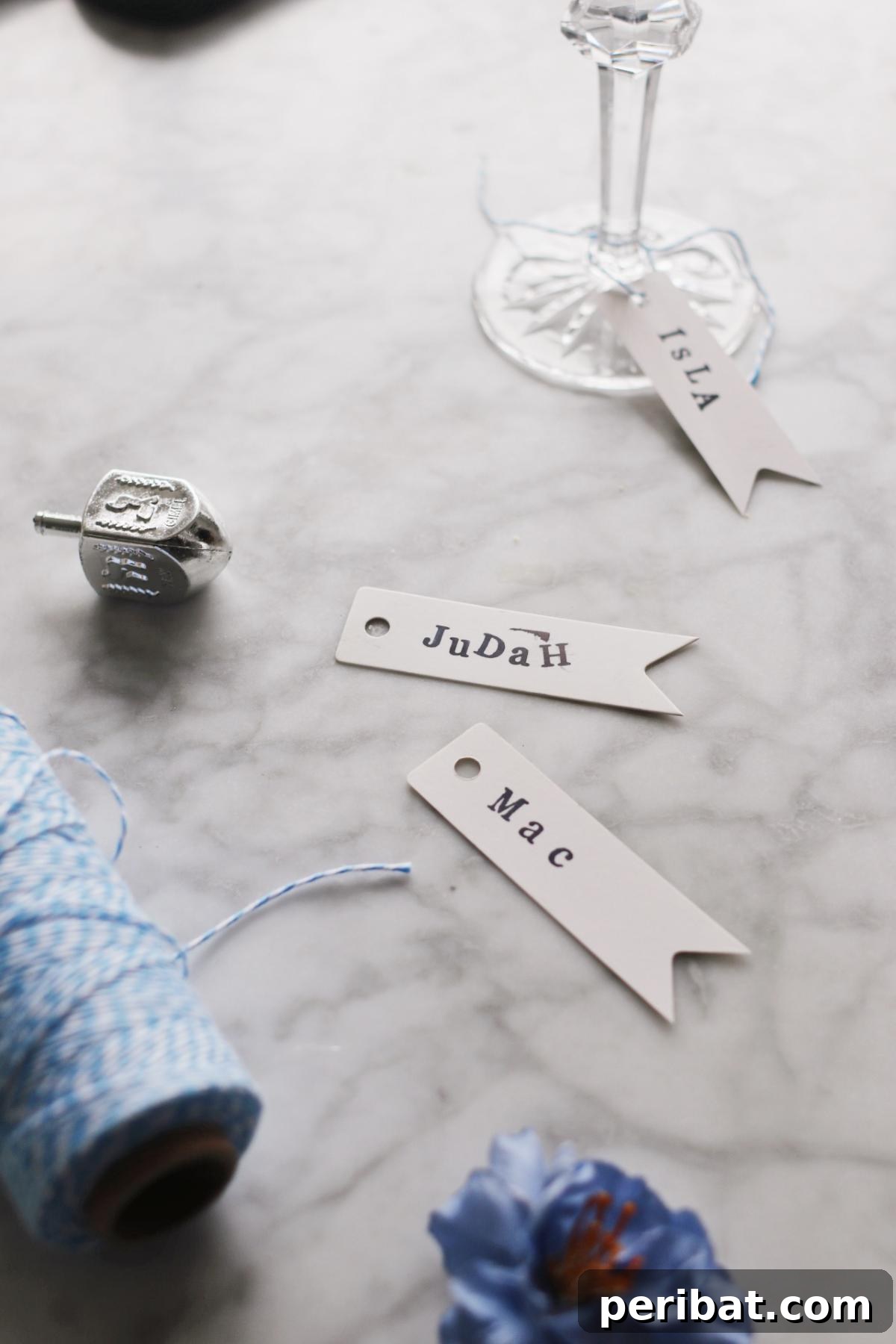 DIY Stamped Place Cards for Any Occasion. Displays place cards created using various stamps for names or decorative patterns, offering a personalized and versatile option for any event.