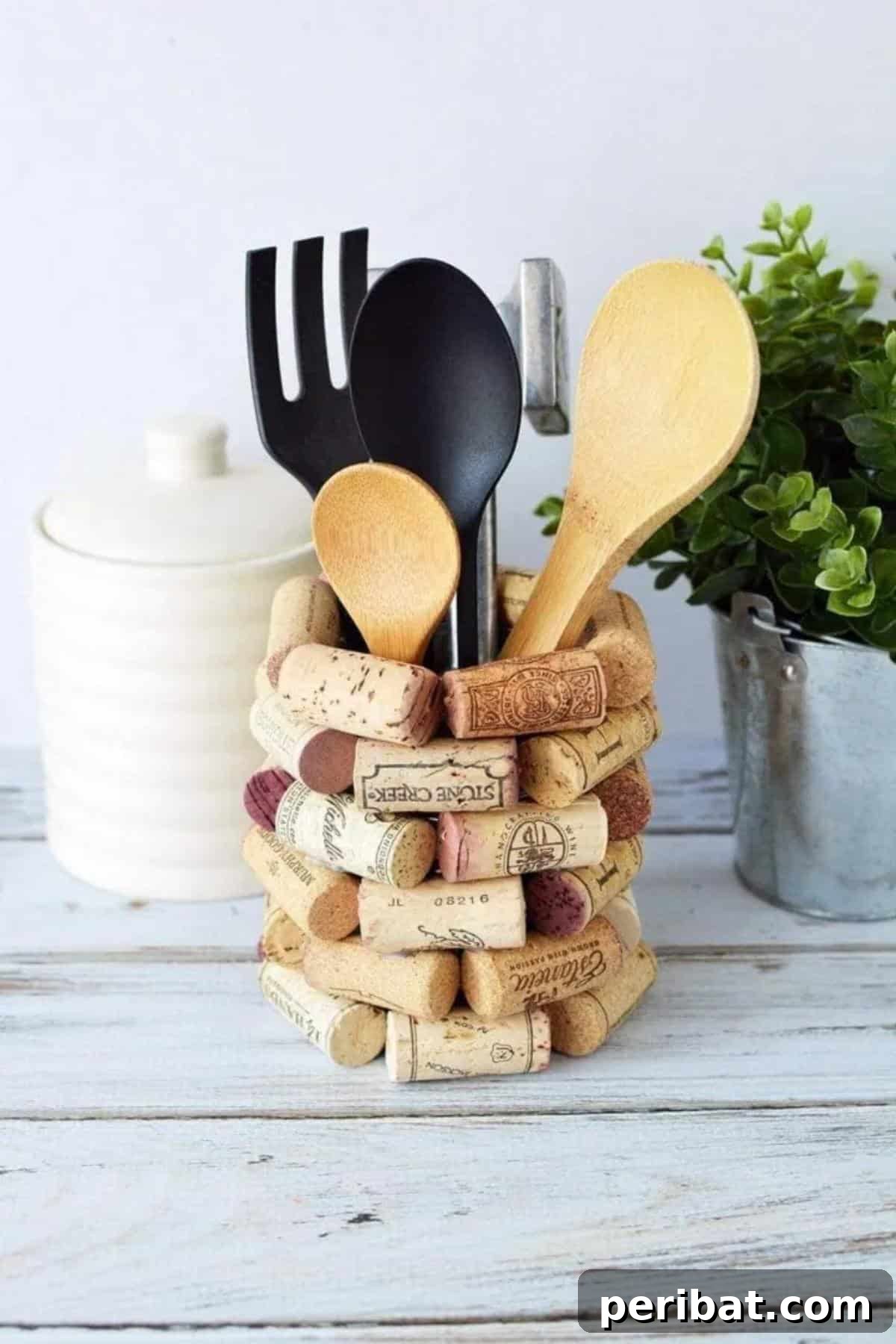 Uncork Your Creativity 50 Wine Cork DIY Projects 40 DIY Wine Cork Kitchen Utensil Holder, a cylindrical holder covered entirely with wine corks, providing a rustic and organized solution for kitchen tools.