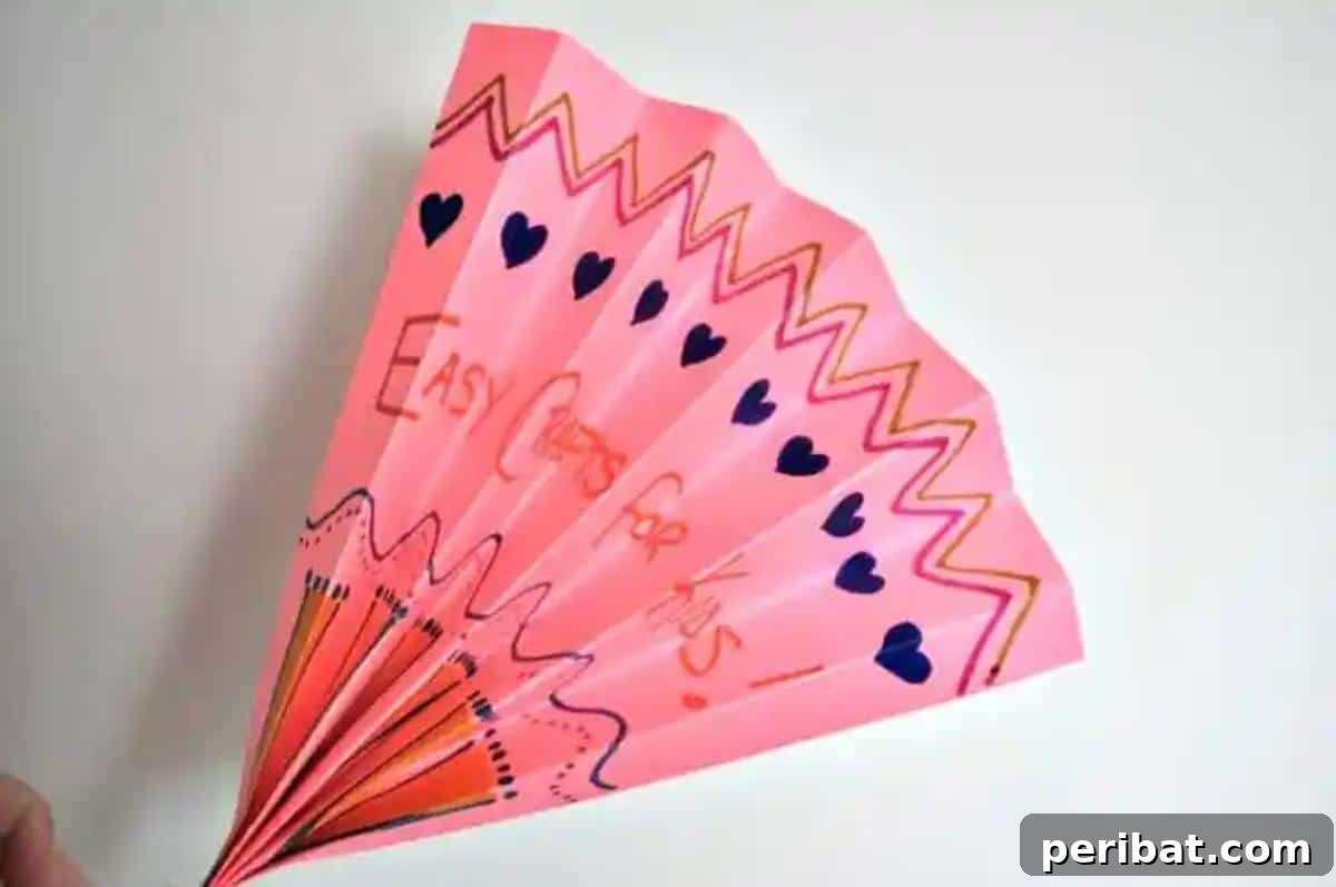 24 Creative DIY Paper Fan Projects 8 A DIY origami paper fan for kids, demonstrating a simple folding technique with options for decorative elements like googly eyes.