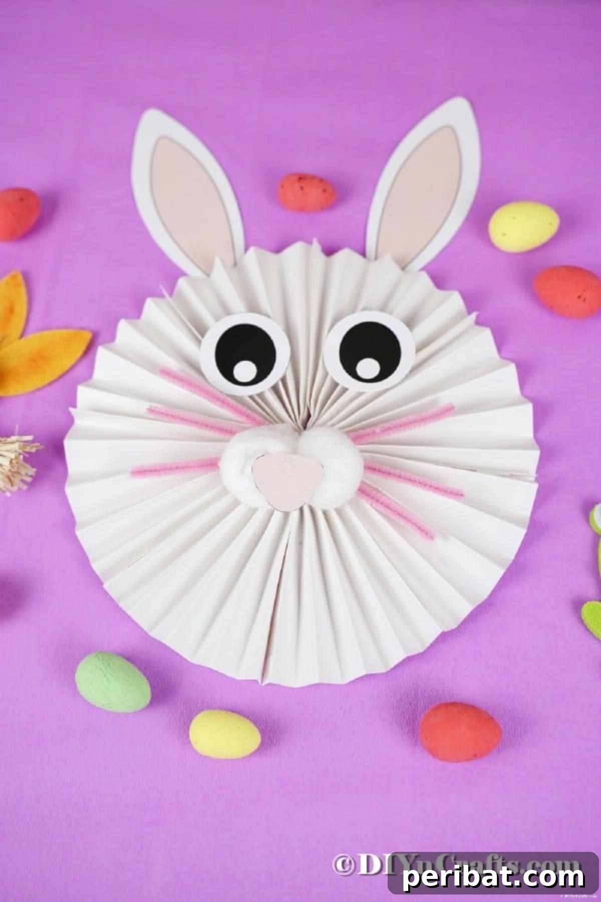 24 Creative DIY Paper Fan Projects 4 An adorable paper fan bunny wall art decoration, ideal for Easter celebrations and kids' craft activities.