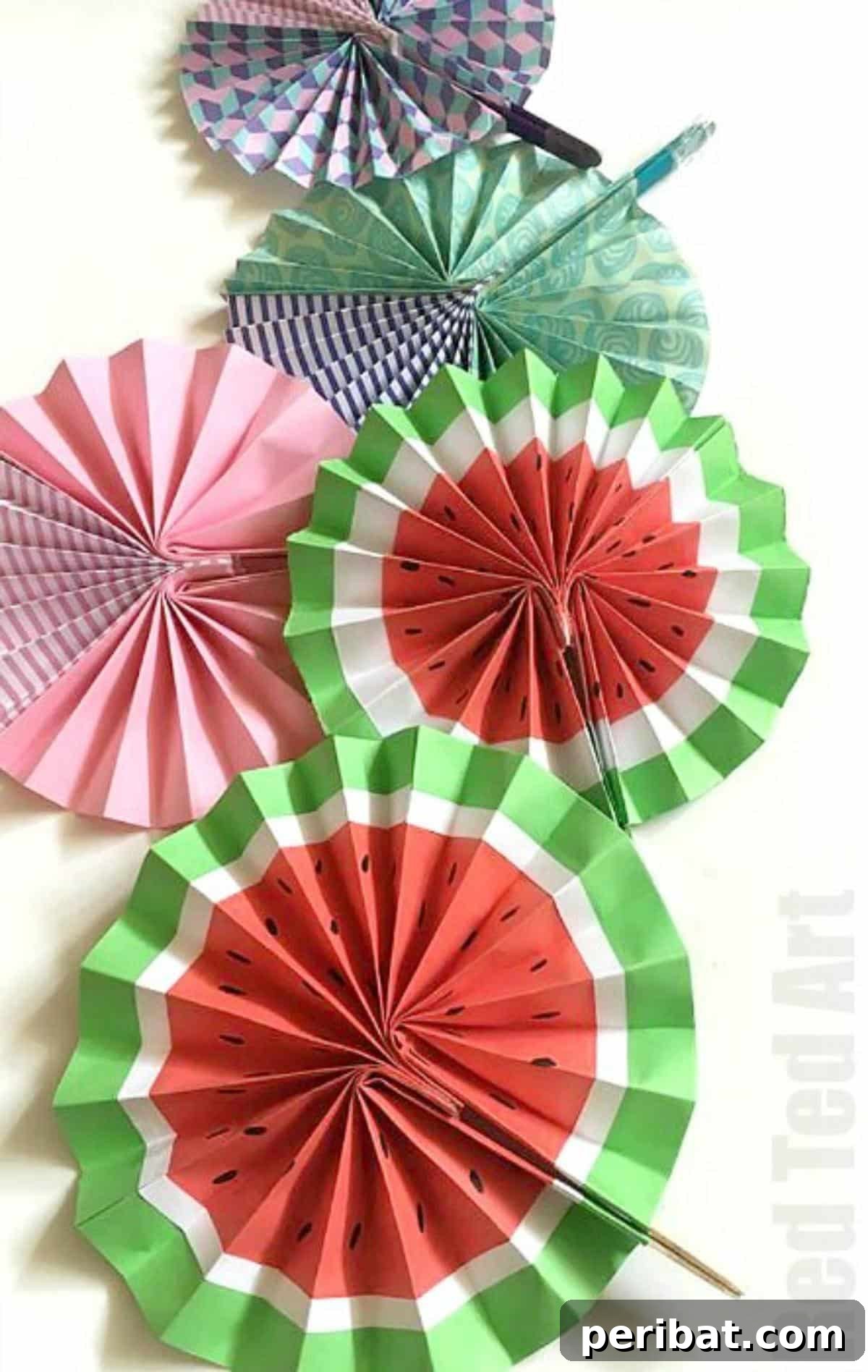 24 Creative DIY Paper Fan Projects 5 Creative DIY paper fan melon designs, featuring upcycled ice lolly sticks for eco-friendly handles, perfect for summer.