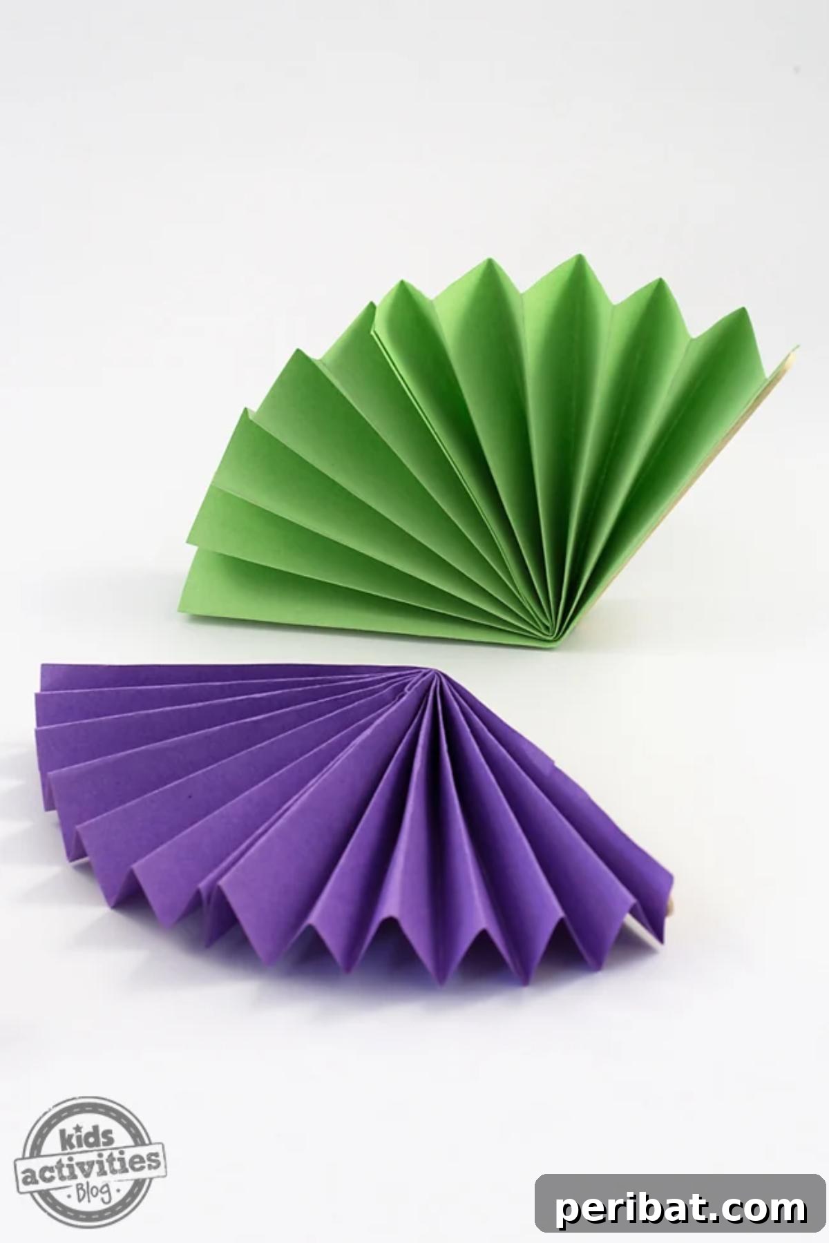 24 Creative DIY Paper Fan Projects 6 Simple and colorful easy paper fans, crafted with construction paper and popsicle sticks, ideal for summer activities.