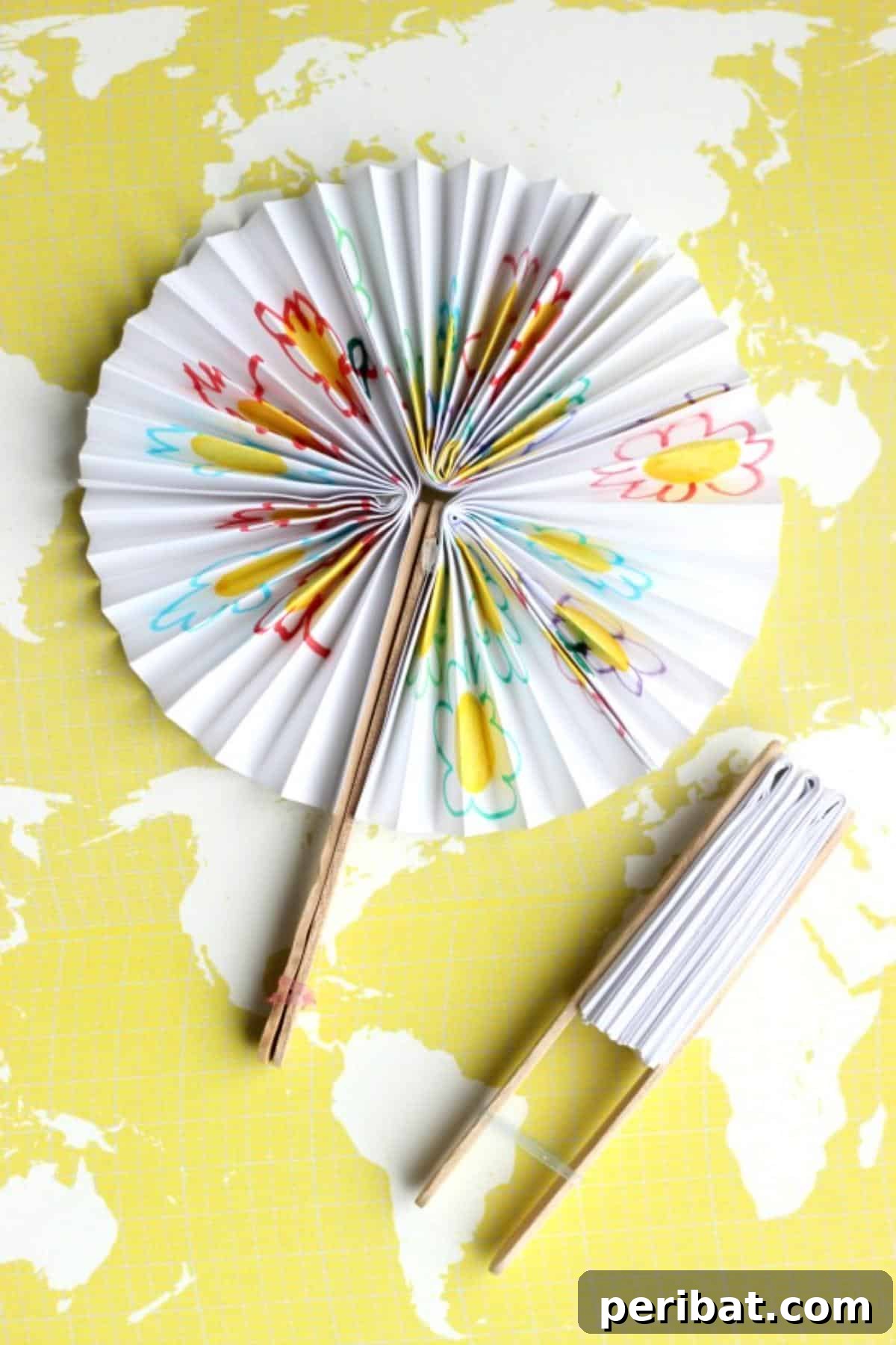 24 Creative DIY Paper Fan Projects 7 Instructions for making DIY pocket folding fans using copy paper, popsicle sticks, and a hairband for portability.
