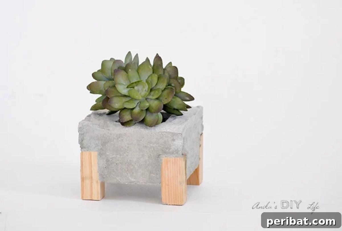 23 Modern Concrete Planter & Vase Projects 17 Wood Feet DIY Concrete Planter, featuring a sophisticated design with tasteful wood accents for modern decor.