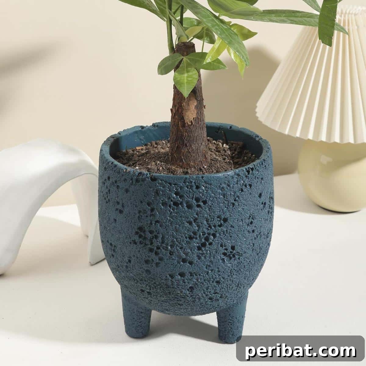 23 Modern Concrete Planter & Vase Projects 19 Concrete Planter with Drainage Hole, a cylindrical structure with gold accents perfect for succulents.