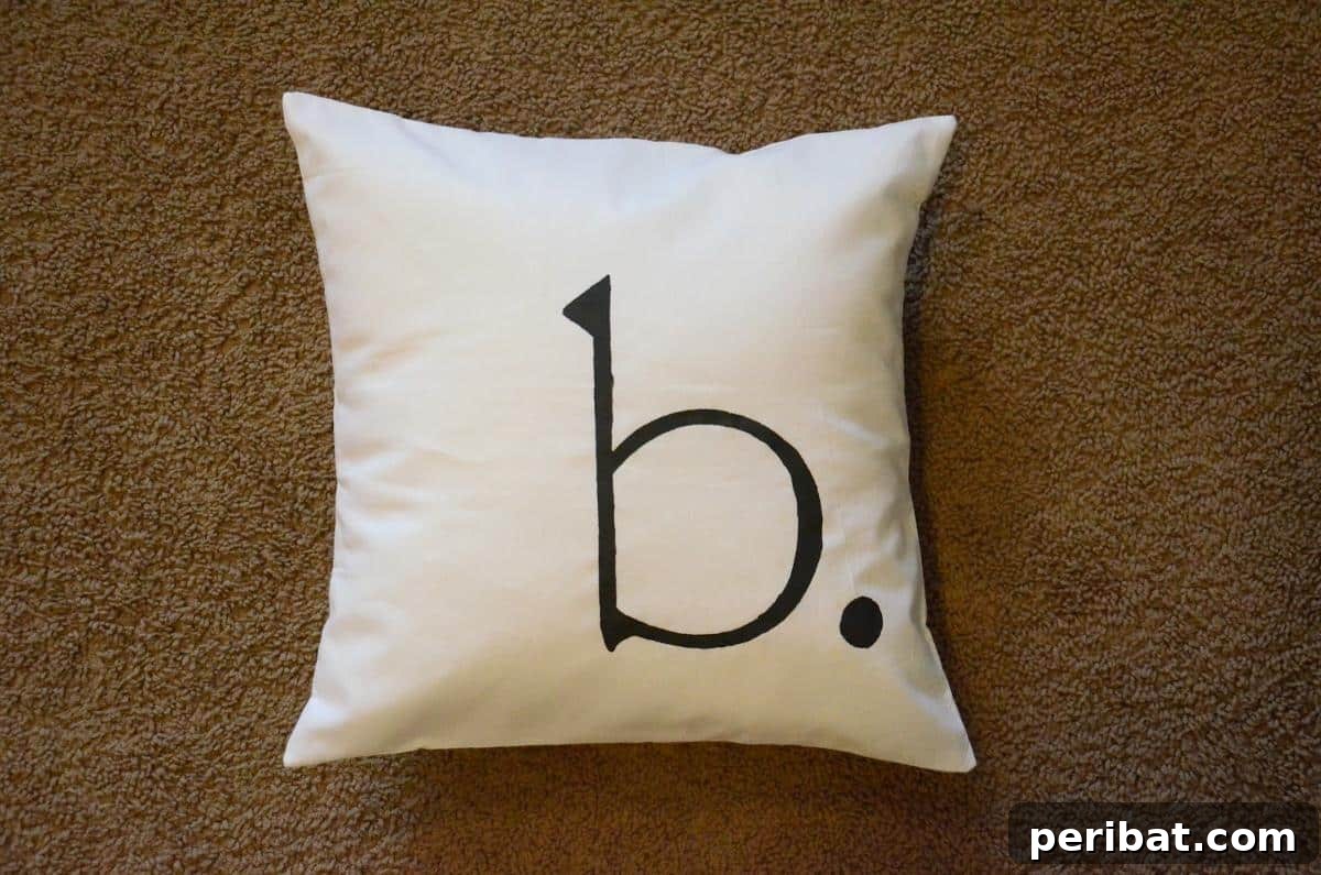47 Inspiring DIY Throw Pillow Designs 36 An elegant monogrammed throw pillow, adding a personalized and sophisticated touch to any room.
