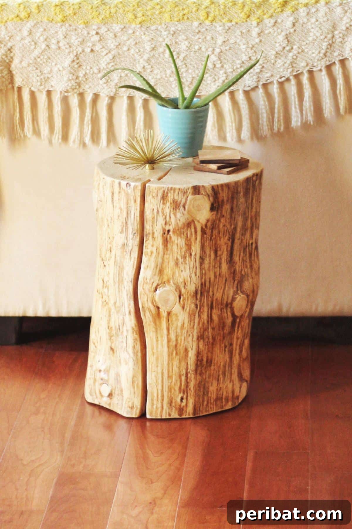 37 Simple and Stylish DIY End Tables 8 Organic DIY natural tree stump side table, showcasing the raw beauty of wood with a smooth, polished top.