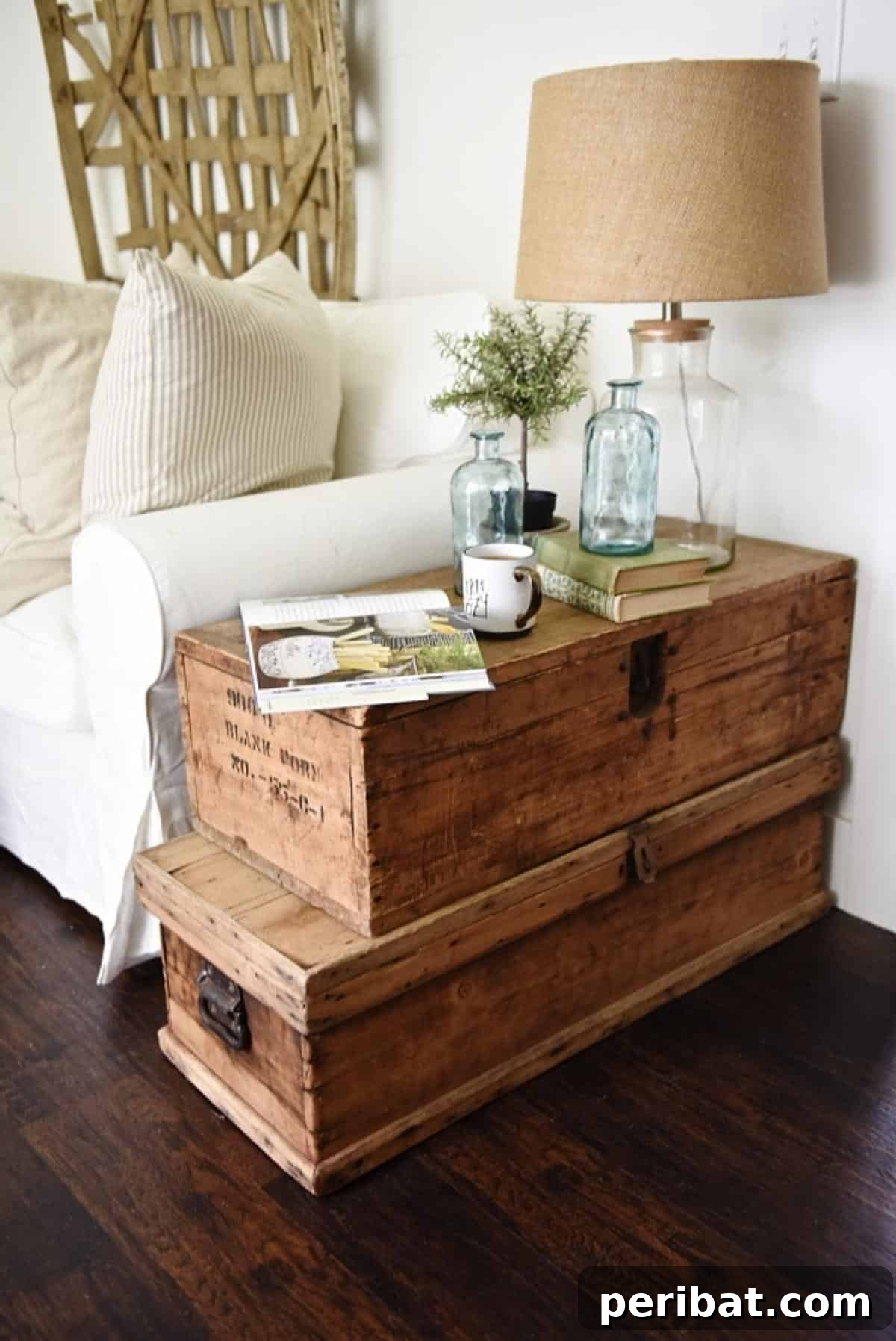 37 Simple and Stylish DIY End Tables 10 Vintage stacked trunk end table, featuring two antique trunks layered to create a unique and functional side table with storage.