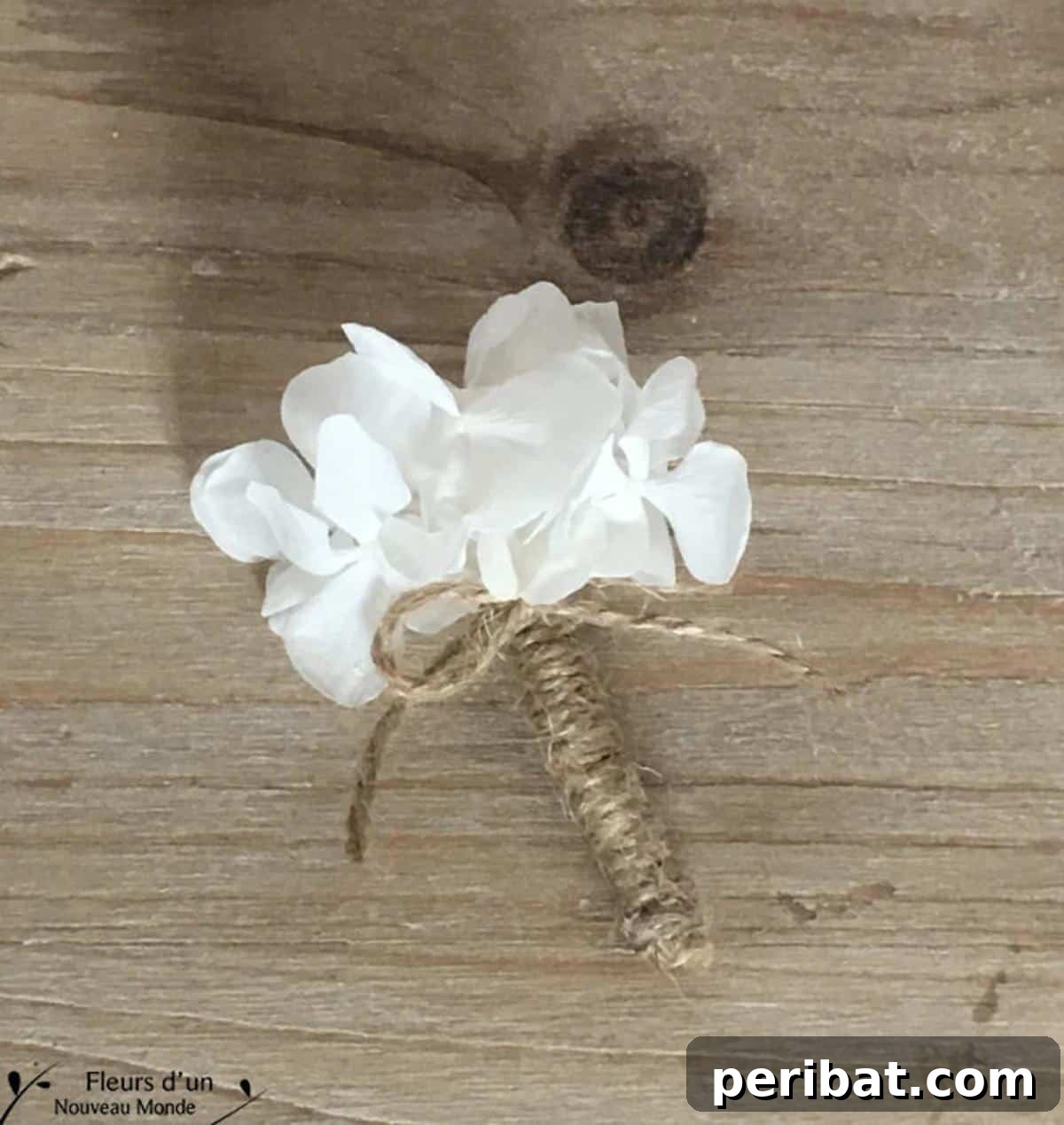 Craft Your Dream Wedding: 20 DIY Accessory Ideas 17 A delicate DIY boutonniere, named 'Douceur,' crafted with preserved hydrangea, a small brooch, and cord, ideal for a nature-inspired wedding.