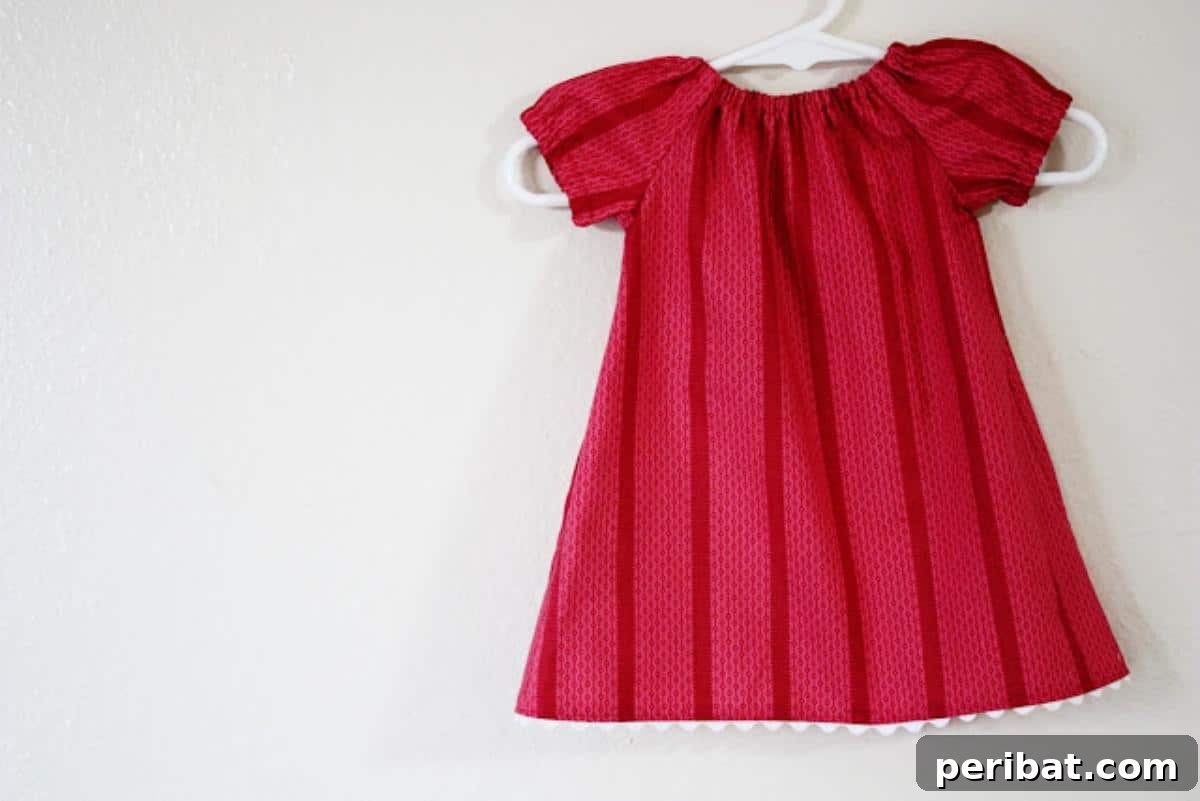 Unlock Your Creativity: 38 Beginner Sewing Projects 11 An adorable Infant Peasant Dress with a gathered neckline and sleeves.