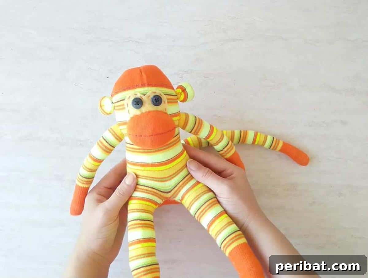 DIY Sock Monkey plushie with striped socks.