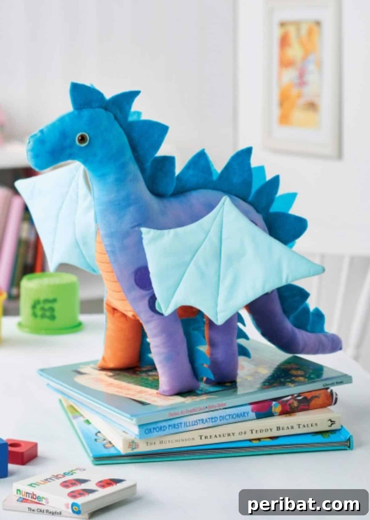 DIY Nigel the Dragon Toy plushie with felt spikes and colorful wings.