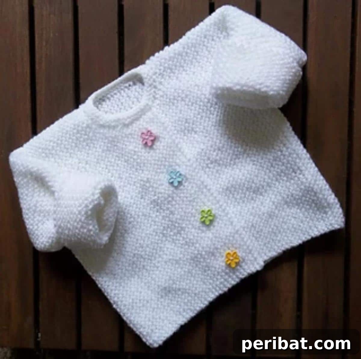 29 Inspiring Circular Knitting Designs 7 A close-up of the Little Flower Garter Stitch Cardigan for toddlers, showcasing delicate flower motifs and a soft garter stitch texture, available in various sizes.