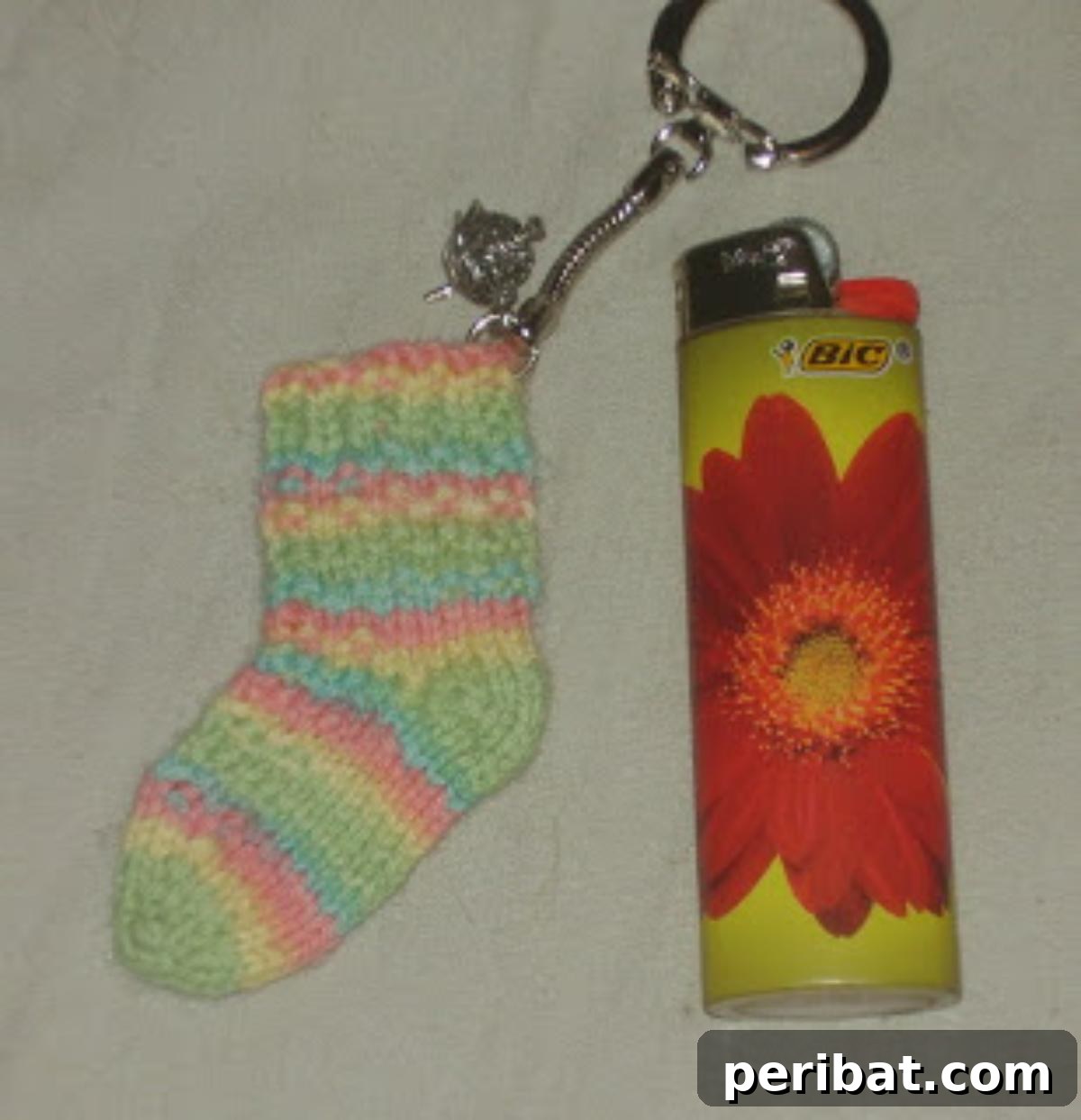 29 Inspiring Circular Knitting Designs 10 A miniature, intricately knitted sock, illustrating the Toe-up Magic Loop Wee Tiny Sock Pattern, perfect for tiny feet and demonstrating precise knitting techniques.