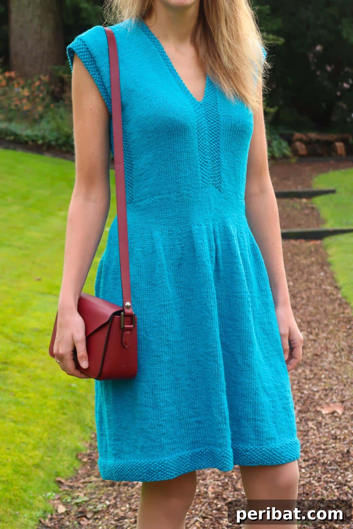 Tenggol Sweater Dress, a flattering knit dress with a V-neck for warm days.