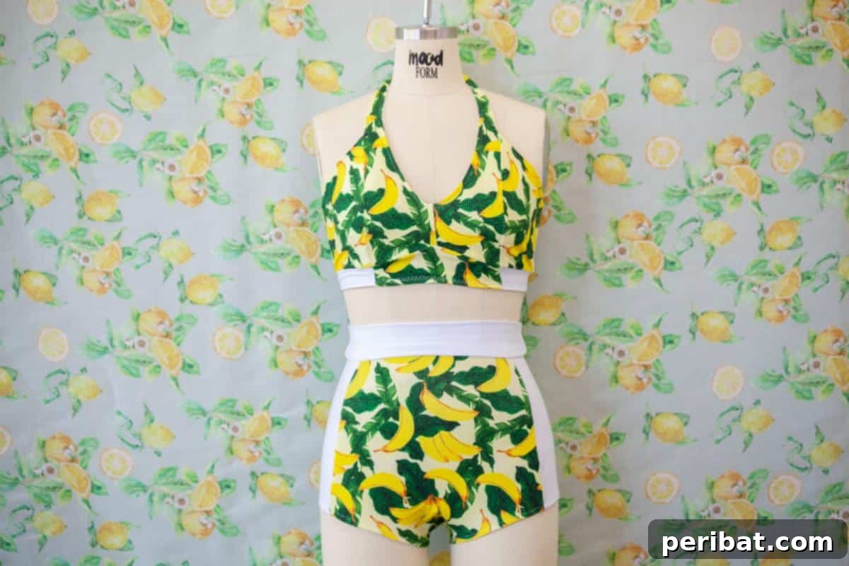 The Cordia High-Waisted Swimsuit features a stylish halter neckline and comfortable high-waist bottom.