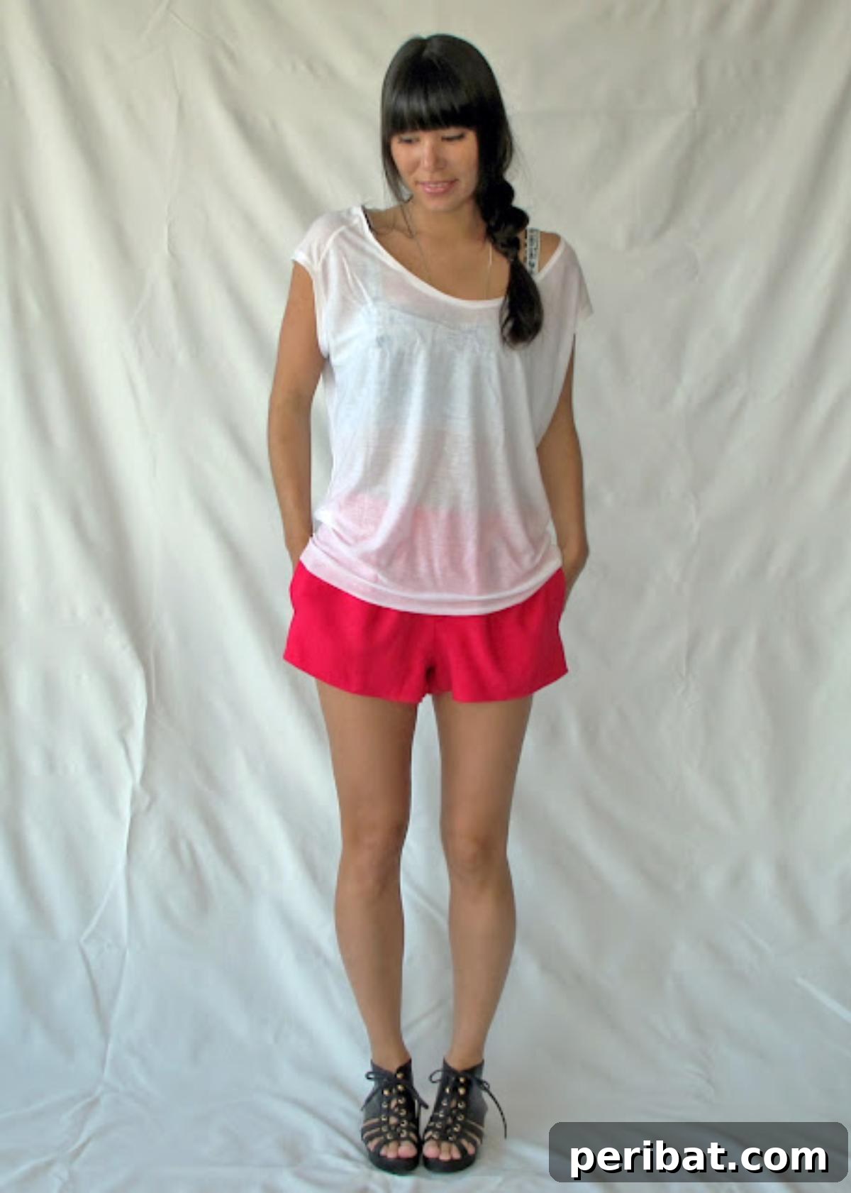 38 Creative T-Shirt Sewing Projects 14 A young girl smiling and wearing 'The Elise Tee', a delightful blend of a tank top and a muscle tee, featuring fun patterns.