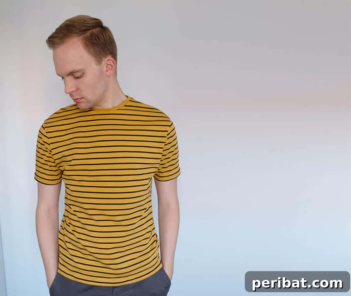 38 Creative T-Shirt Sewing Projects 20 A man wearing a white DIY men's t-shirt, illustrating the process of tailoring a custom-fit tee from scratch.