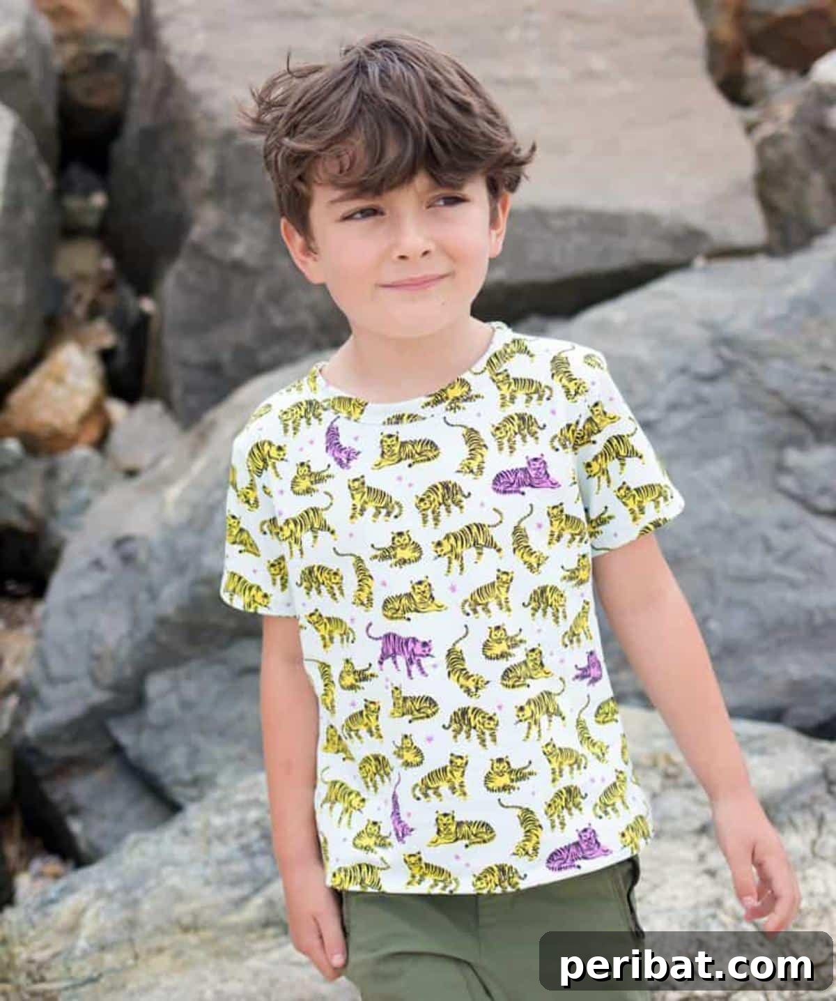 38 Creative T-Shirt Sewing Projects 3 A young boy happily wearing a blue cotton jersey t-shirt. This free sewing pattern is perfect for creating comfortable kids' clothes.