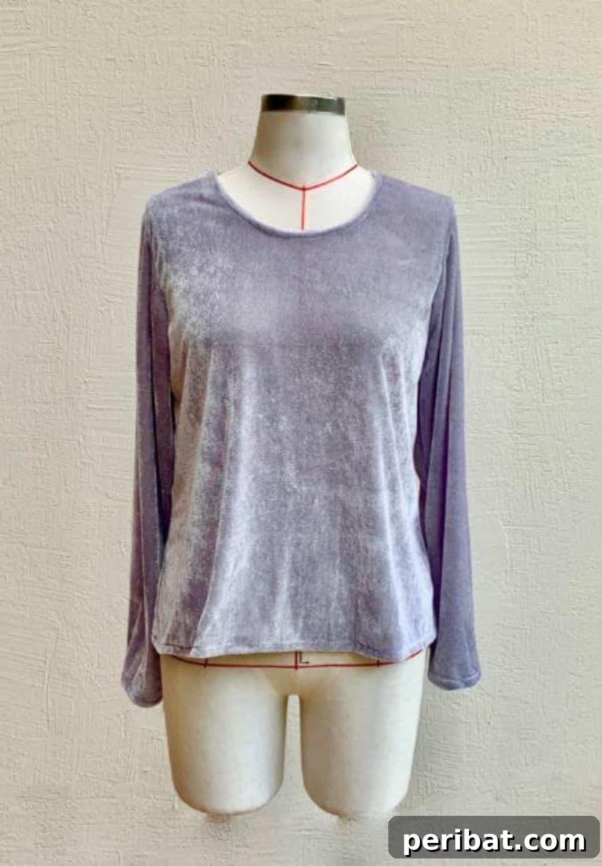 38 Creative T-Shirt Sewing Projects 25 A person showcasing a simple long-sleeved T-shirt made from soft knit fabric, ideal for lounging or as a pajama top.
