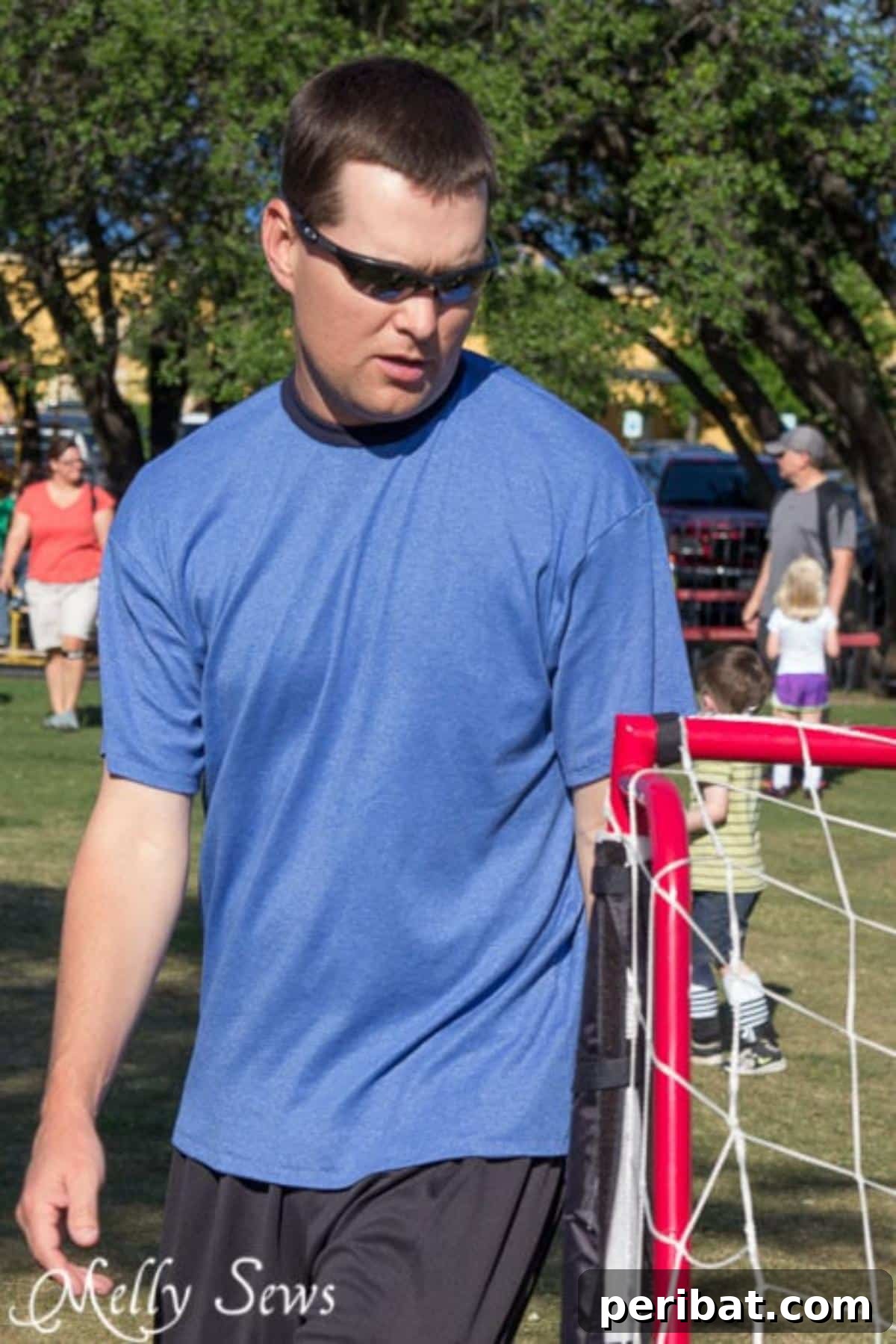 38 Creative T-Shirt Sewing Projects 4 A stylish man modeling a fitted men's T-shirt, highlighting the classic V-neck option of this versatile sewing pattern.