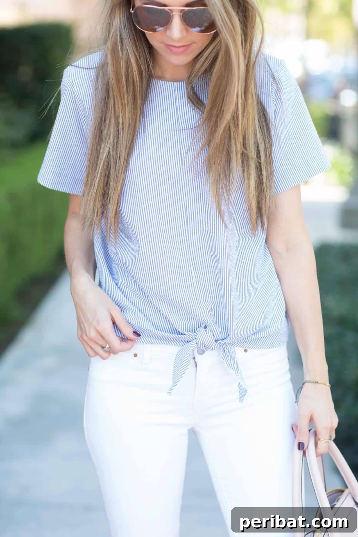38 Creative T-Shirt Sewing Projects 32 A woman wearing a stylish tie-front top with a playful knot, perfect for adding a touch of summer elegance to any outfit.