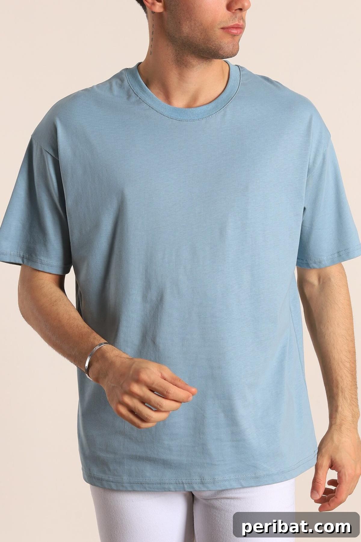 38 Creative T-Shirt Sewing Projects 38 A man wearing a perfectly tailored black T-shirt, illustrating the result of a detailed step-by-step men's T-shirt sewing pattern.