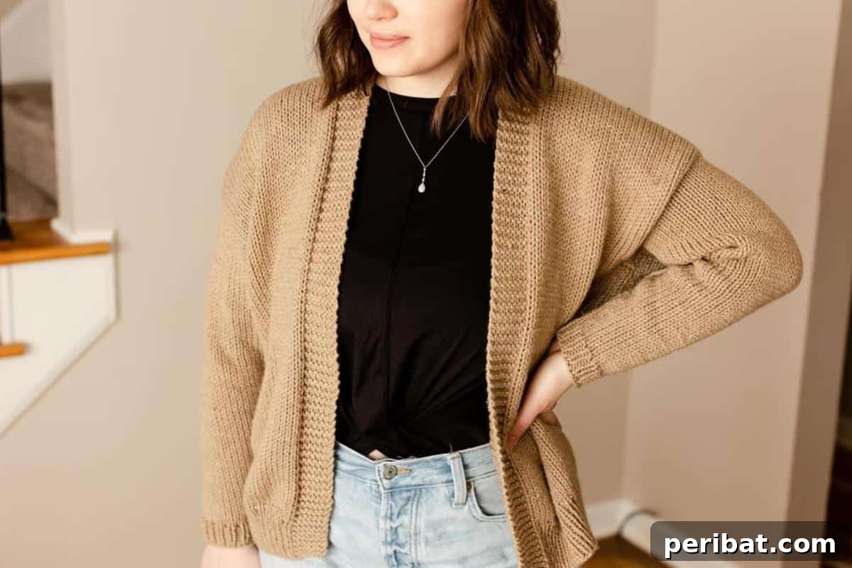 A simple, elegant beginner cardigan in a light neutral color, perfect for first-time garment knitters.