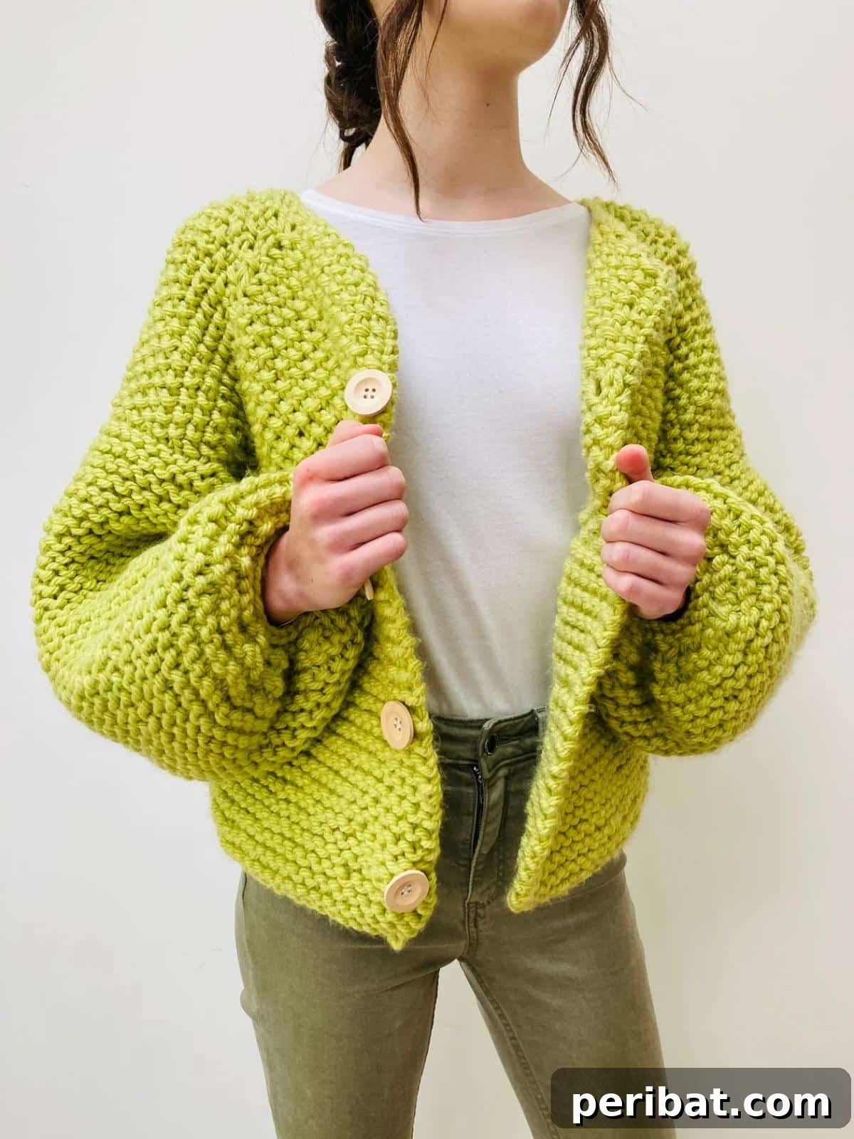 A generously sized Super Chunky Knitted Cardigan in a muted tone, emphasizing its cozy feel and substantial knit.