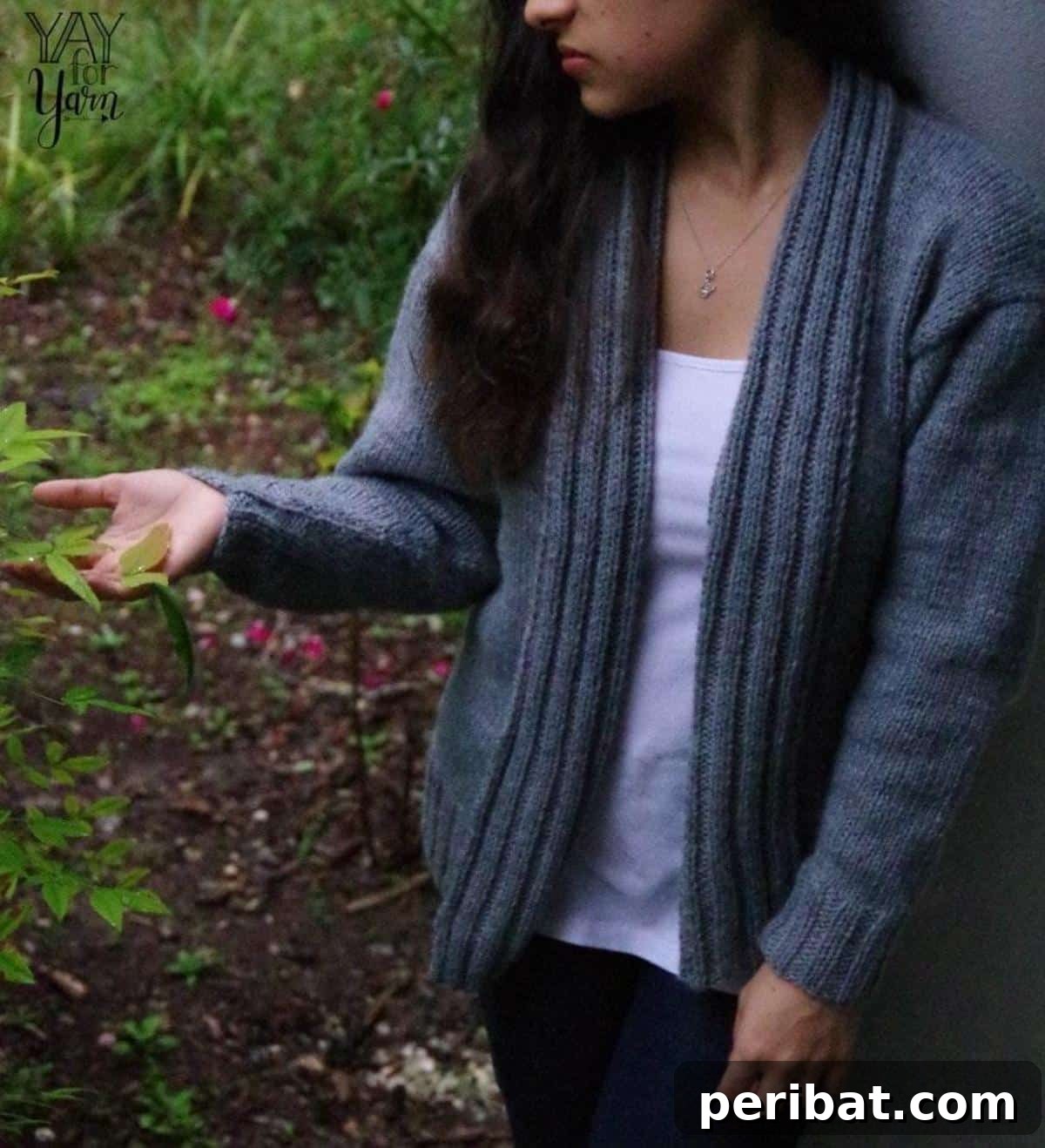 A woman models a cozy, simple slouchy cardigan in a dark shade, ideal for layering during colder months.