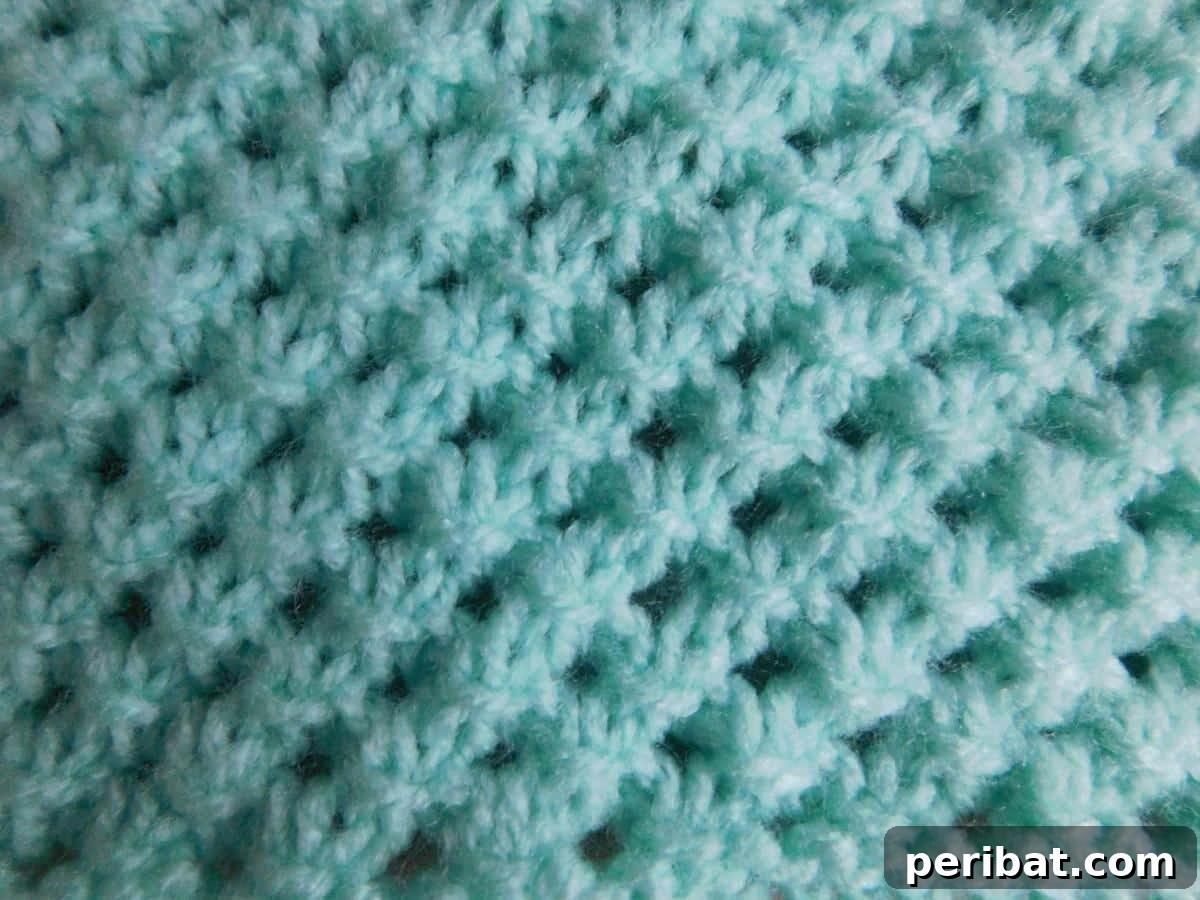 38 Adorable Baby Blanket Knitting Patterns 17 Danika Baby Blanket - a charming knitted blanket with a distinctive texture and pattern.