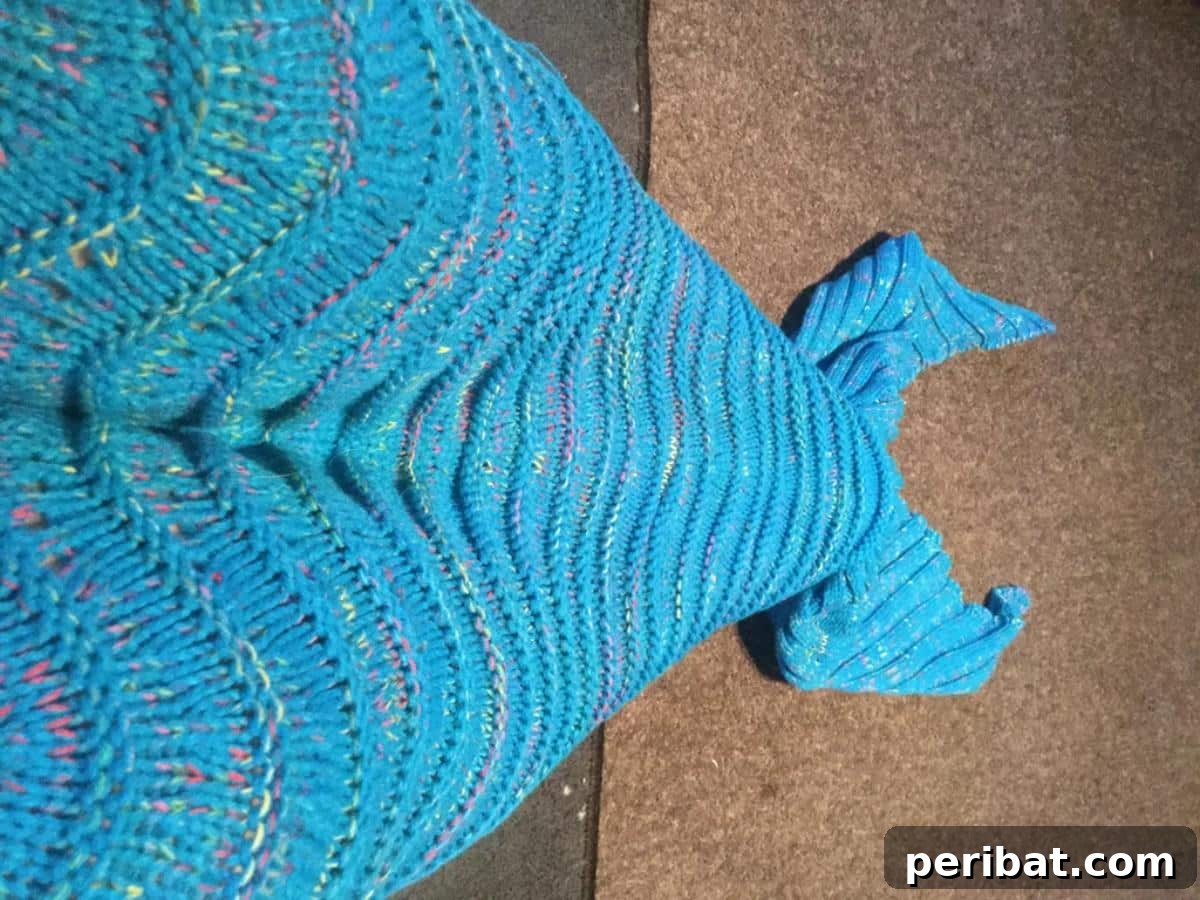 DIY Mermaid Blanket, a step-by-step guide for knitting an aquatic escape with DK yarn.