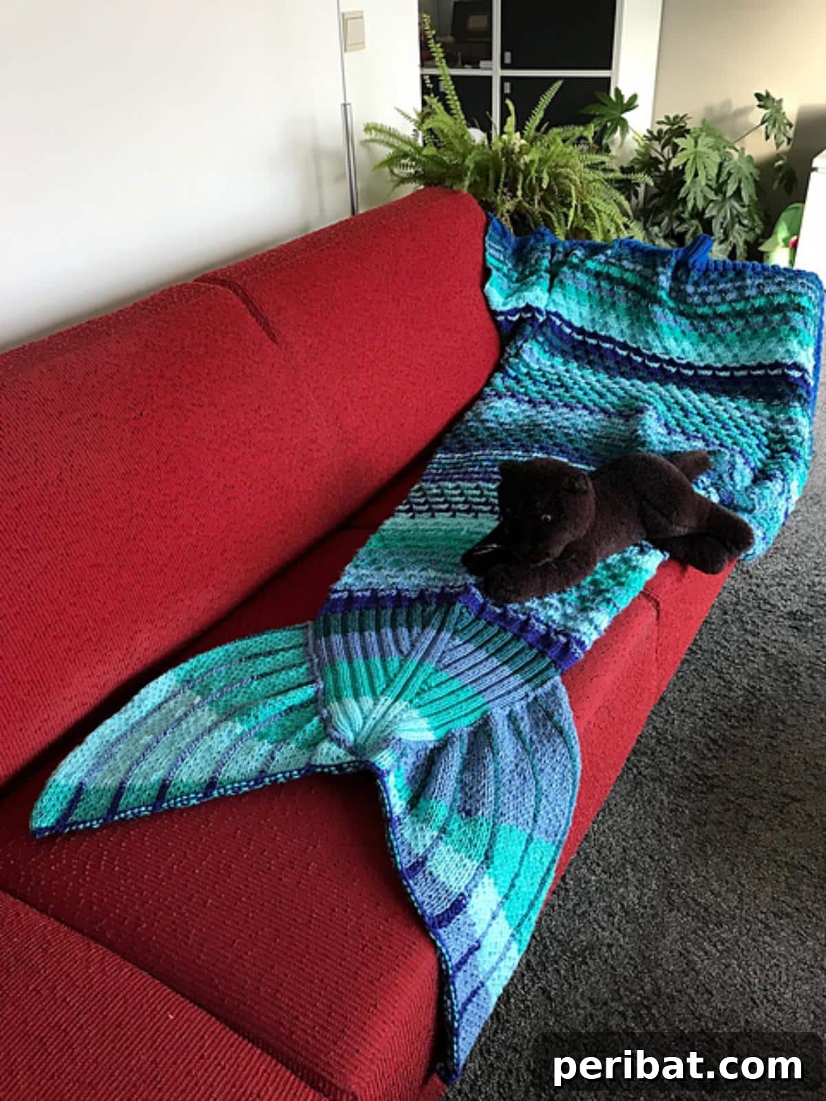 Siren Tail Blanket, a unique knitted design with a foot pouch, blending comfort and mermaid whimsy.