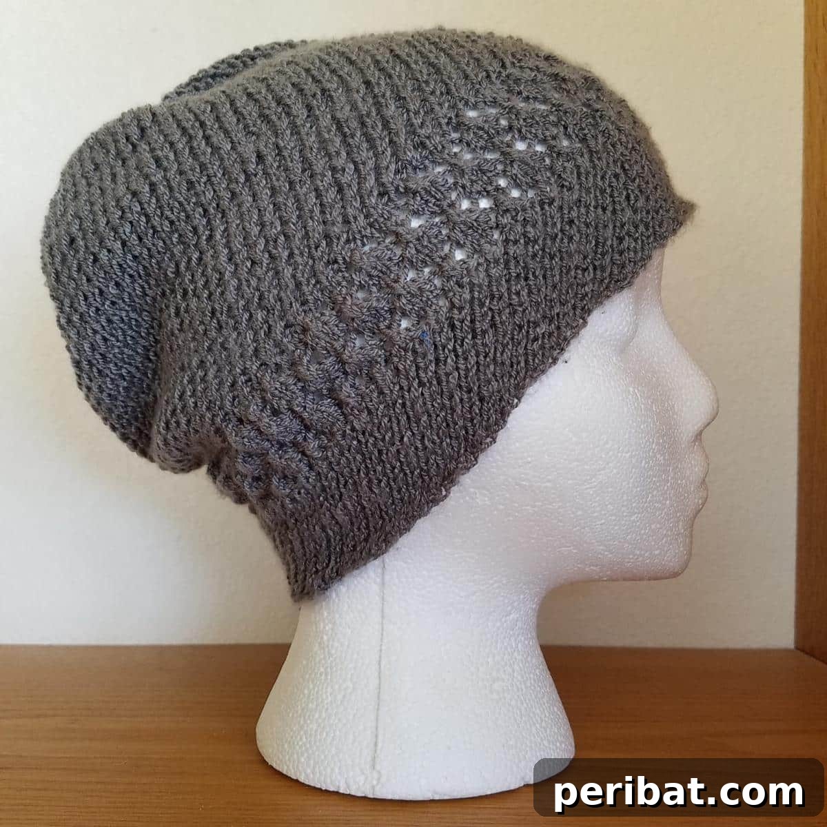 38 Cozy Slouchy Hat Knitting Patterns 15 Kelsey Lace and Spiral Hat knitting pattern, combining delicate lace with spiraling stitches for a unique and stylish accessory.
