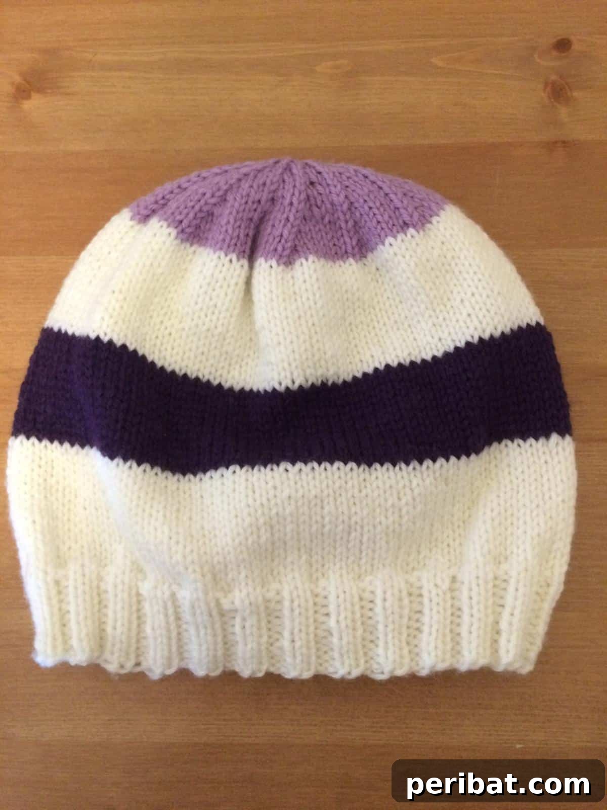 38 Cozy Slouchy Hat Knitting Patterns 19 The iconic Hawkeye Hat knitting pattern, blending superhero colors into a wearable tribute for fans.