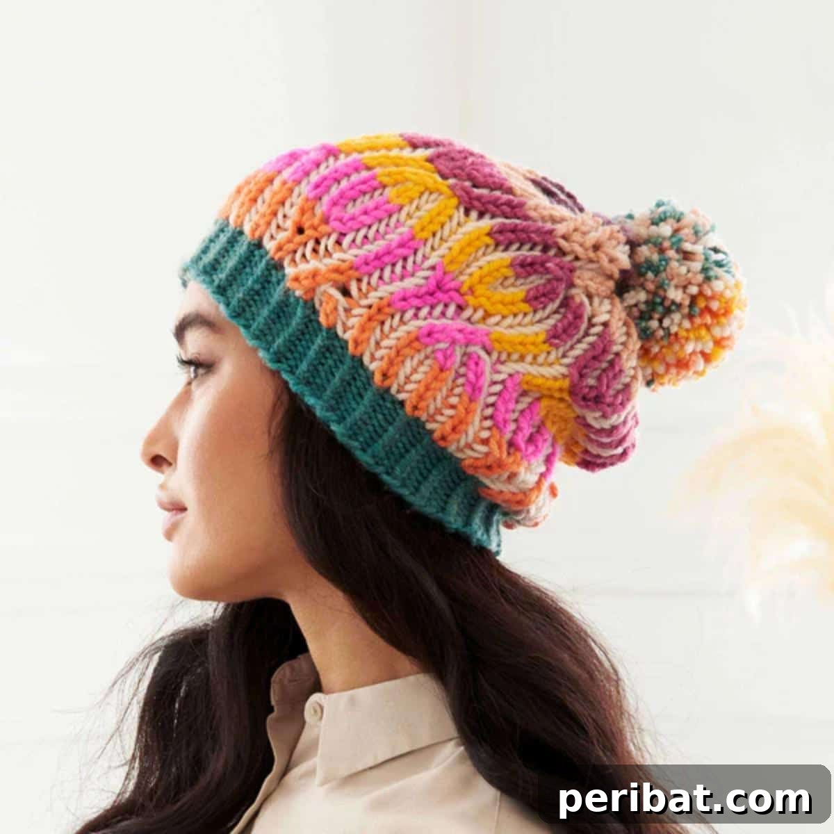 38 Cozy Slouchy Hat Knitting Patterns 7 Elegant Caron Brioche Cables Knit Hat pattern, showcasing intricate brioche stitch and mock cables with a playful pom-pom.