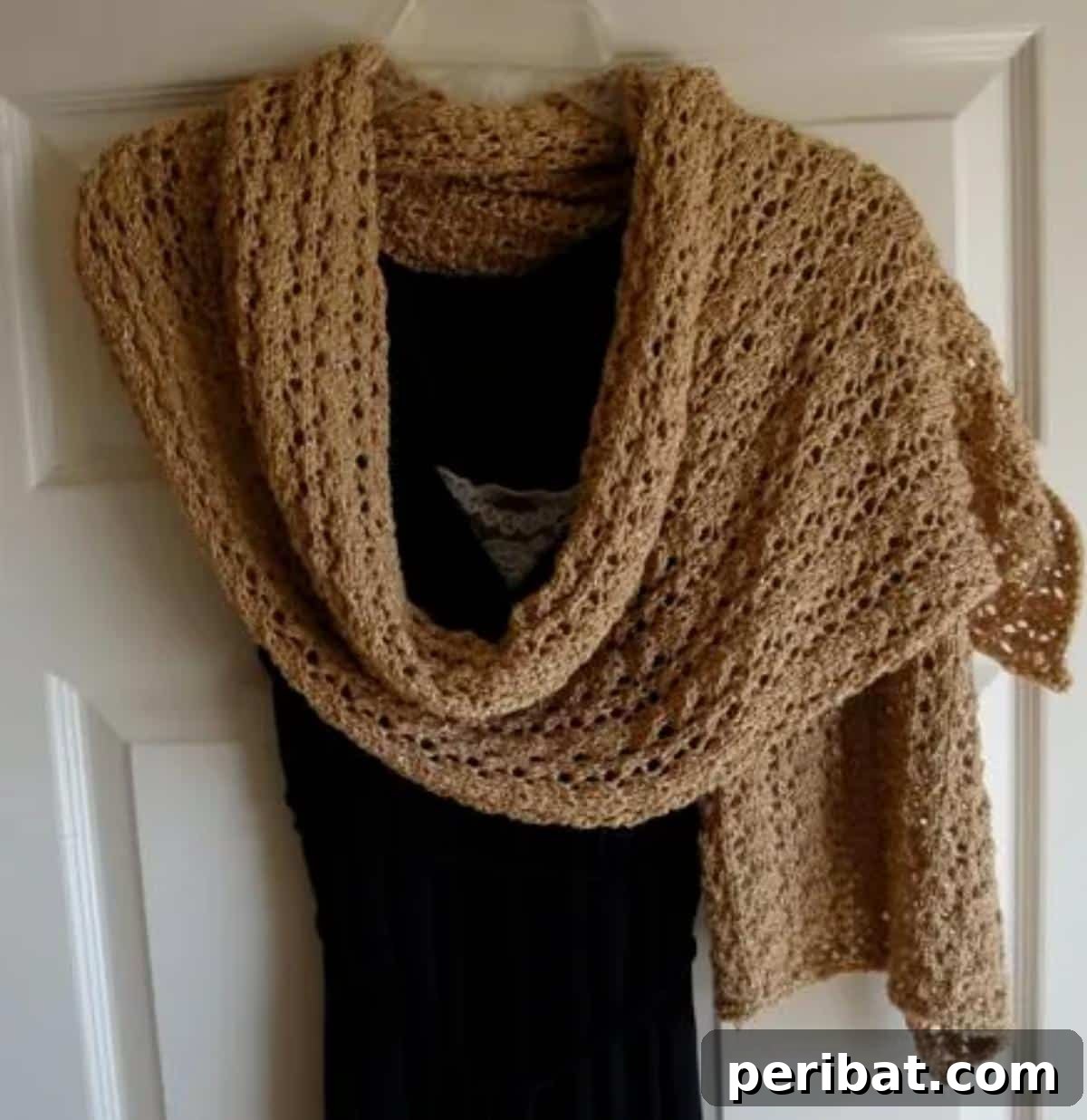 Divine Comfort: 36 Knitted Prayer Shawl Designs 14 A glamorous Glitzy Cat’s Paw Lace Wrap, featuring a metallic yarn and a glossy finish that adds a refined glimmer, perfect for making a statement at any event.
