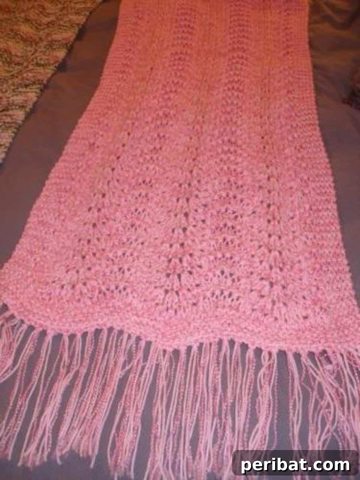 Divine Comfort: 36 Knitted Prayer Shawl Designs 27 A beautiful Pink Shawl, combining soft and deep pinks, serving as a powerful sign of support and unity for those affected by breast cancer.