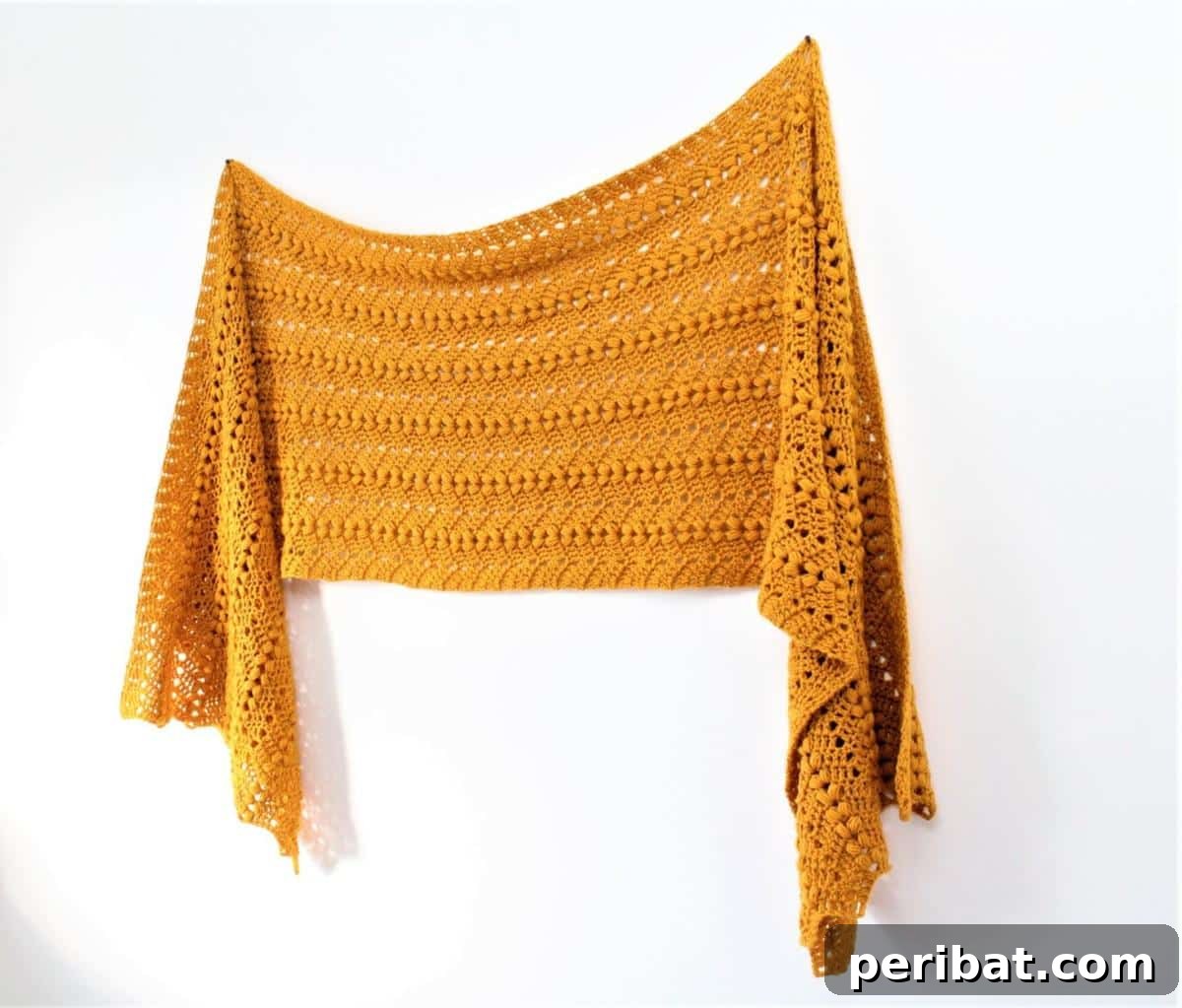 Divine Comfort: 36 Knitted Prayer Shawl Designs 35 A lightweight and airy Bobble Ripple Shawl, featuring a playful bobble and ripple pattern in an easy repeat, adding texture and charm to any outfit.