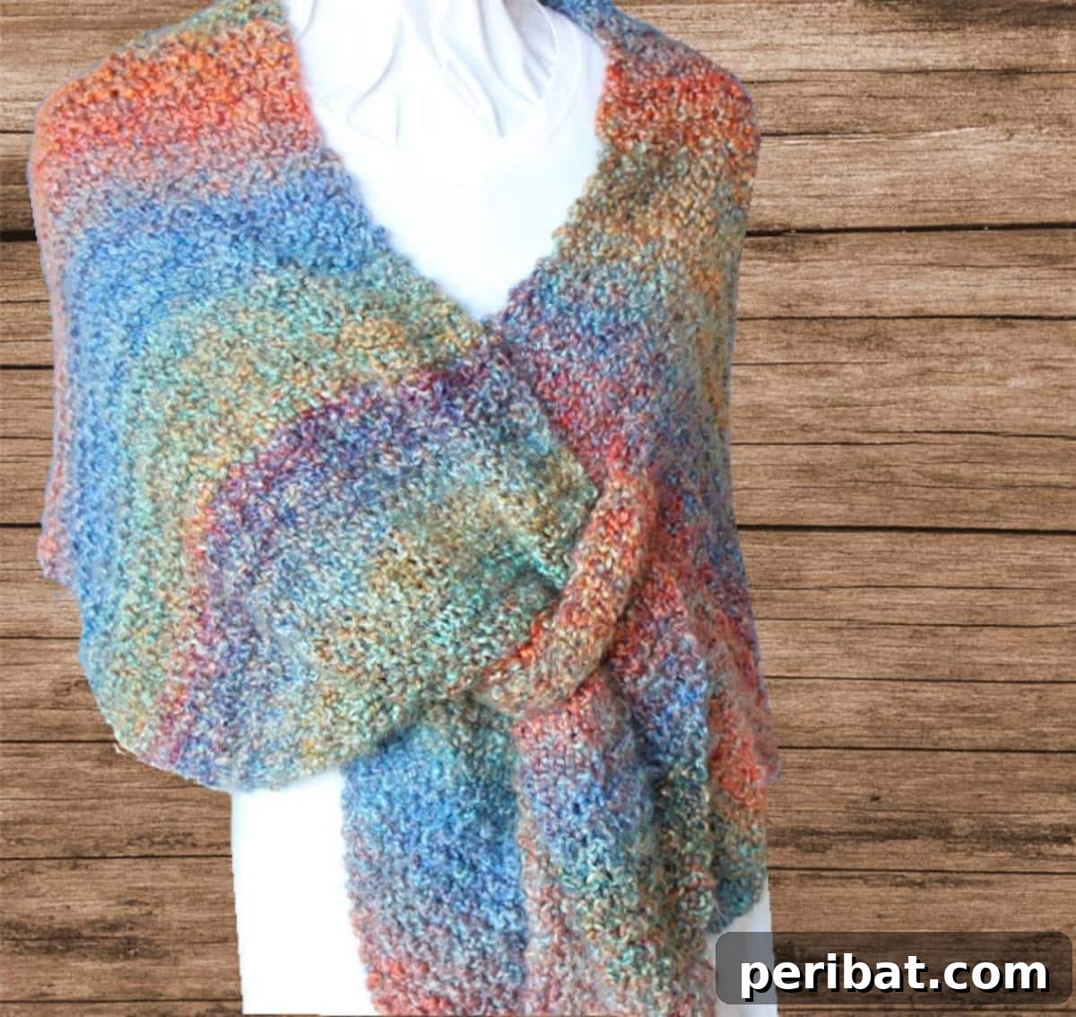 Divine Comfort: 36 Knitted Prayer Shawl Designs 37 An attractive Knit Wrap With Tab Closure, featuring a unique fastening that keeps it in place while adding an exquisite, trendy touch to any outfit.