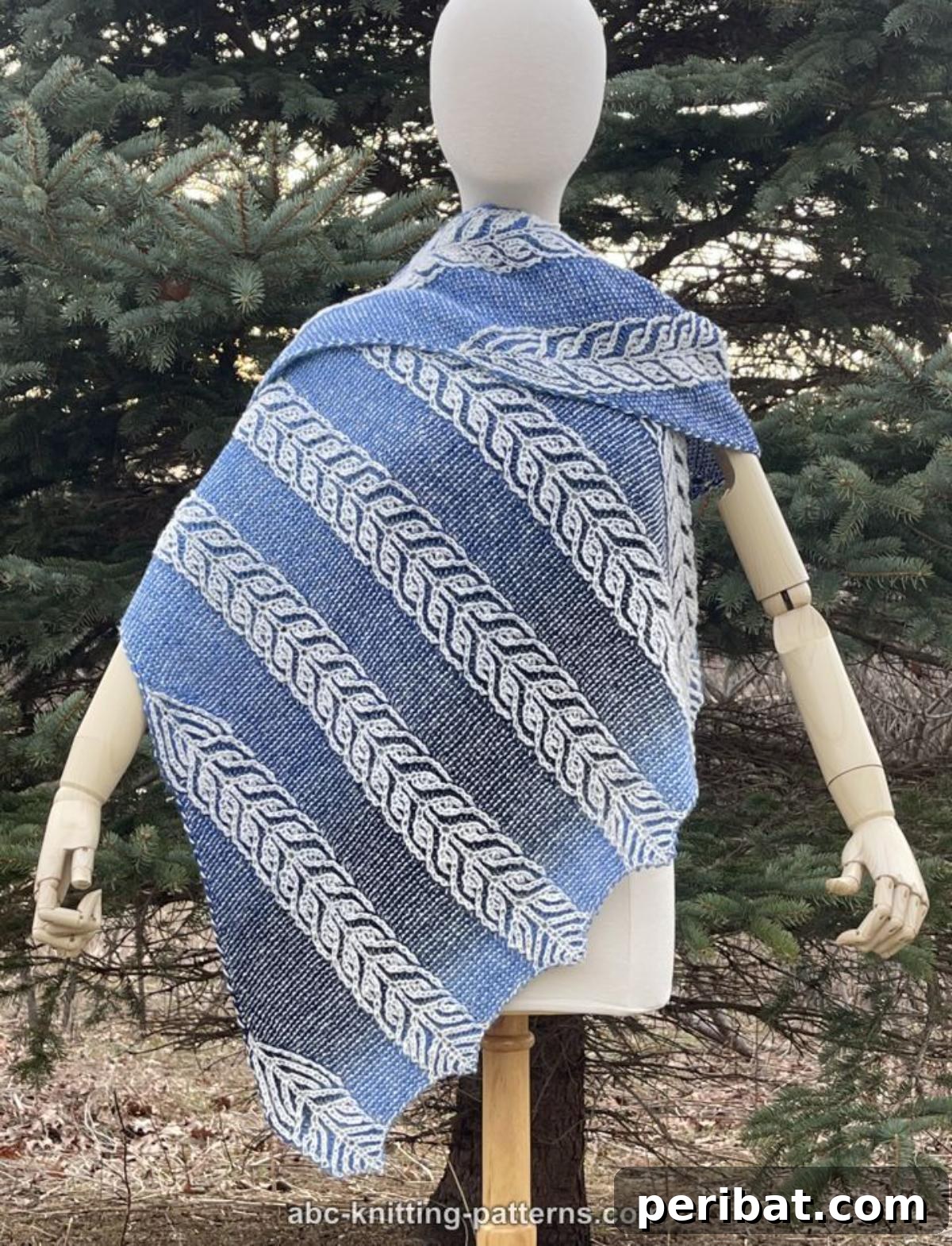 Foxtail Triangle Brioche Shawl, featuring an intricate, fern-like cable pattern and an organic asymmetric design in a soft, muted color.