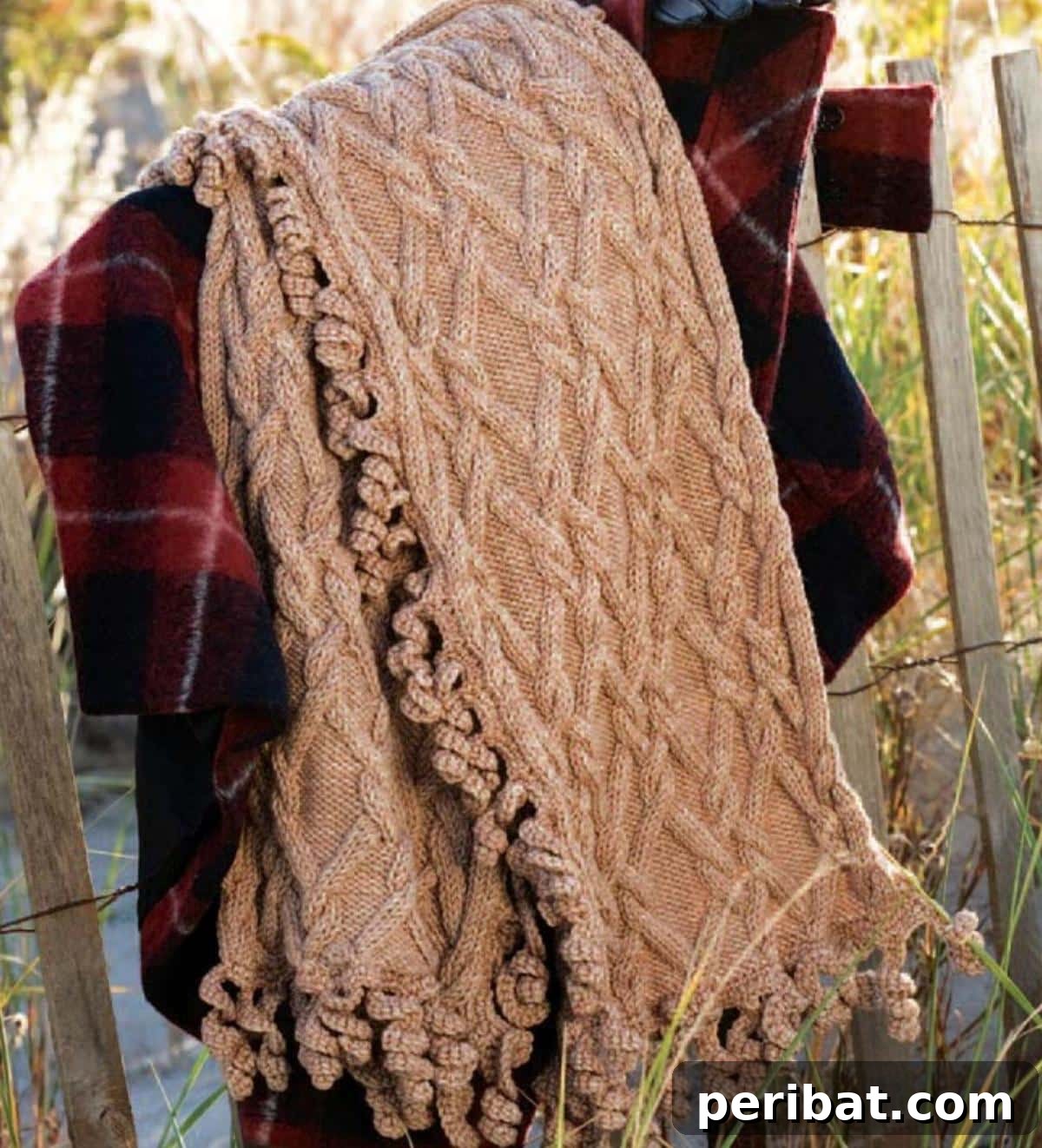 18 Timeless Aran Knitting Patterns 5 Cabled Twirl Wrap combining knitting and crochet.