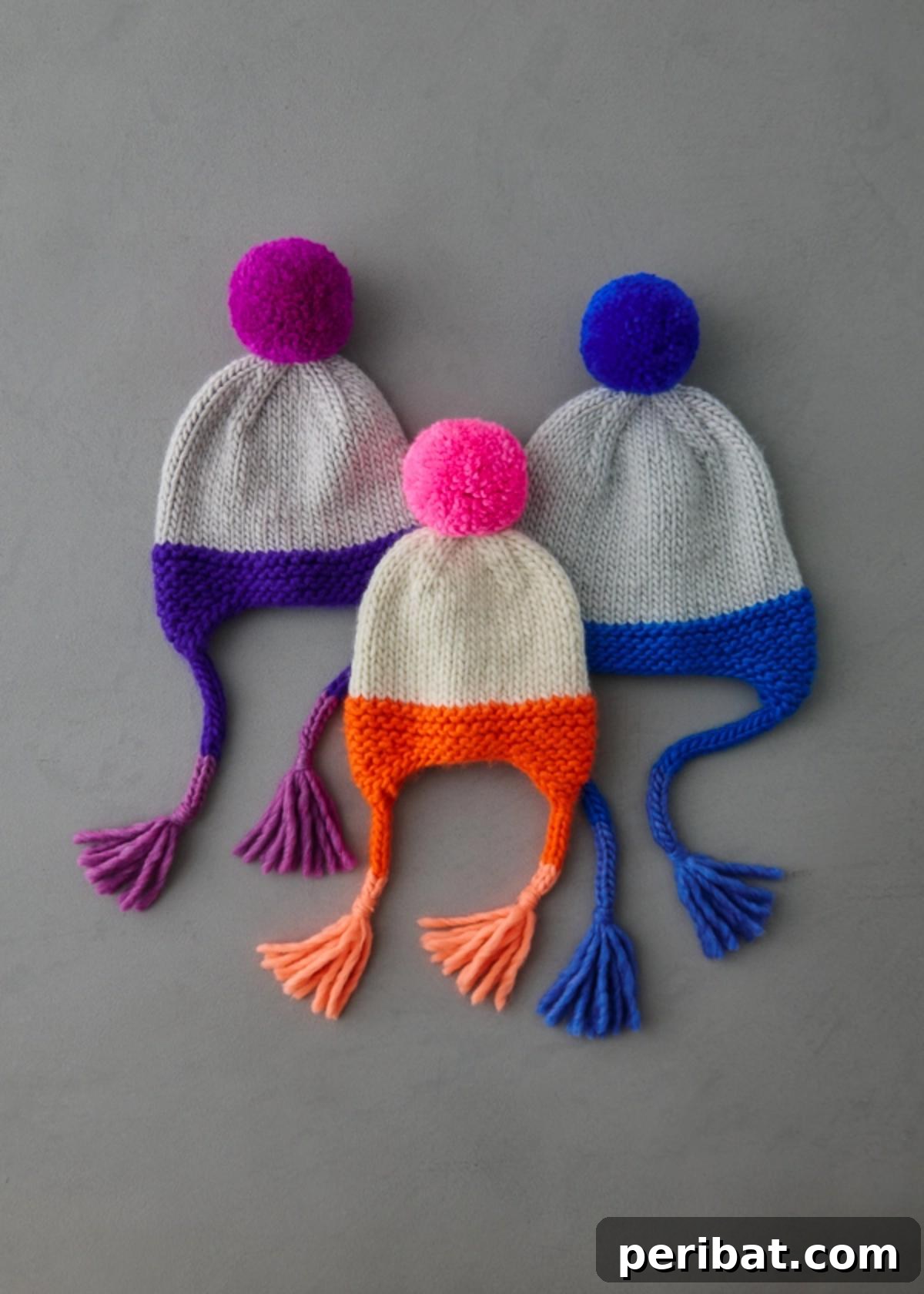 32 Cozy Ear Flap Hat Knitting Designs 11 A festive Merry Ear Flap Hat with bright tassels and fluffy pompoms, perfect for holidays.