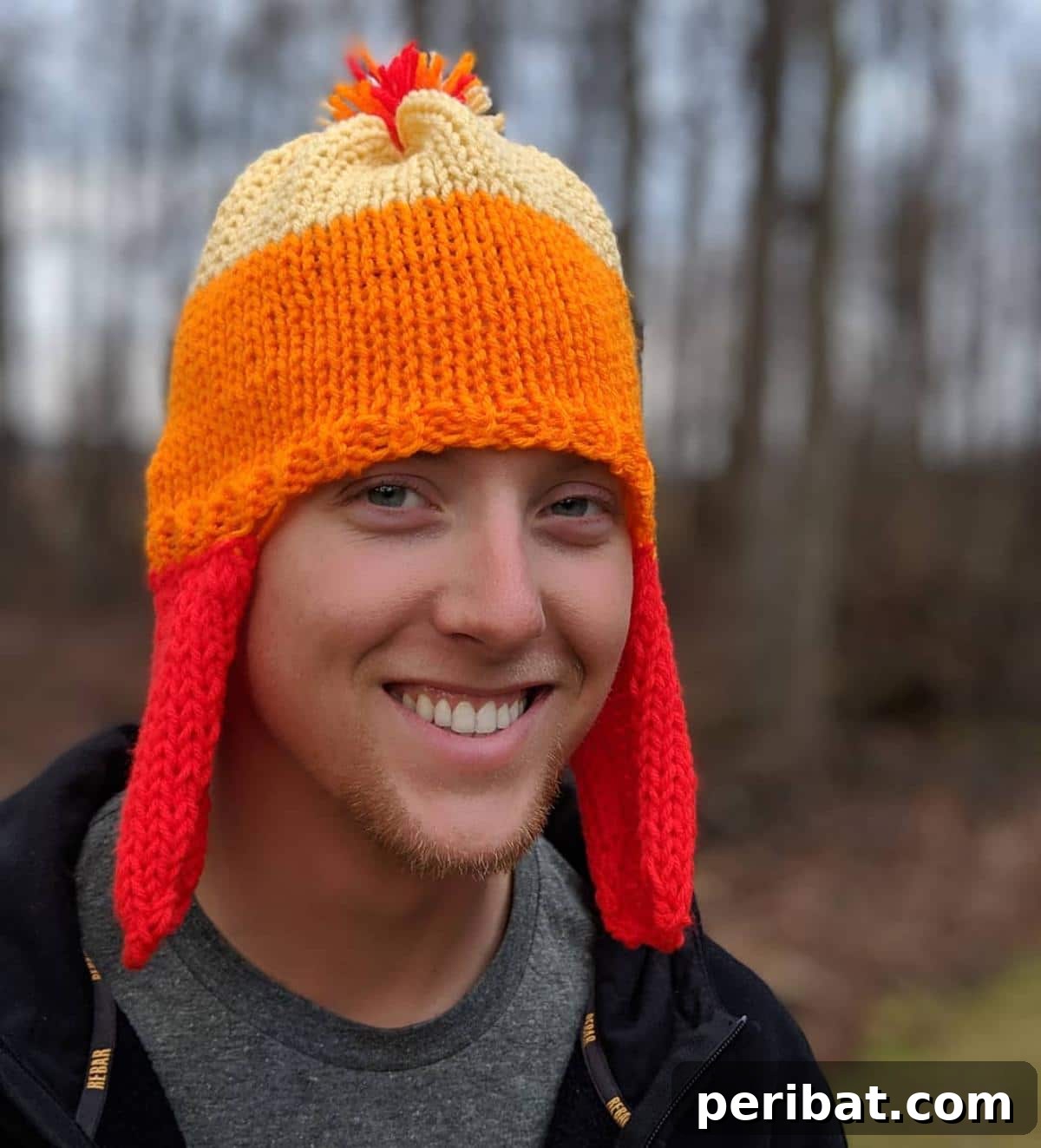 32 Cozy Ear Flap Hat Knitting Designs 15 A vibrant, Firefly Inspired Hat featuring gradients of warm, fiery colors that resemble glowing fireflies.