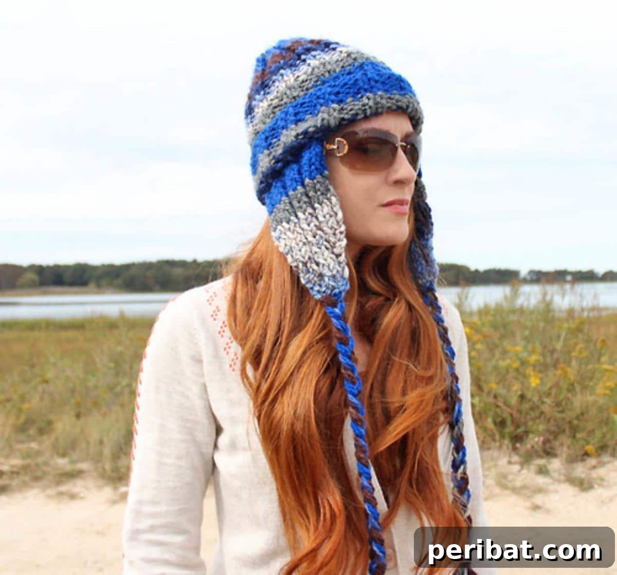 32 Cozy Ear Flap Hat Knitting Designs 3 A cozy, horizontally striped earflap beanie in multiple colors, perfect for keeping warm.
