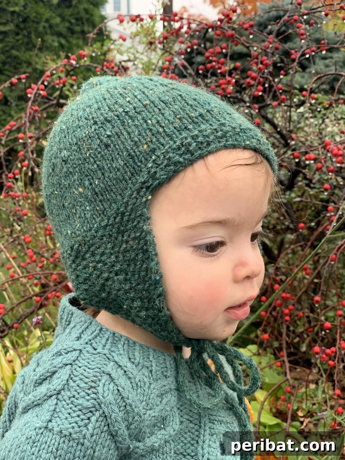 32 Cozy Ear Flap Hat Knitting Designs 23 Gilda’s Hat, a warm and snug earflap hat for little ones, made from organic wool yarn.