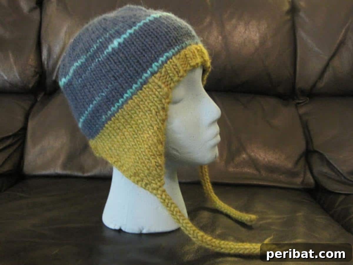 32 Cozy Ear Flap Hat Knitting Designs 24 A simple yet elegant Classic Ear Flap Hat, offering timeless style and cozy comfort for all ages.