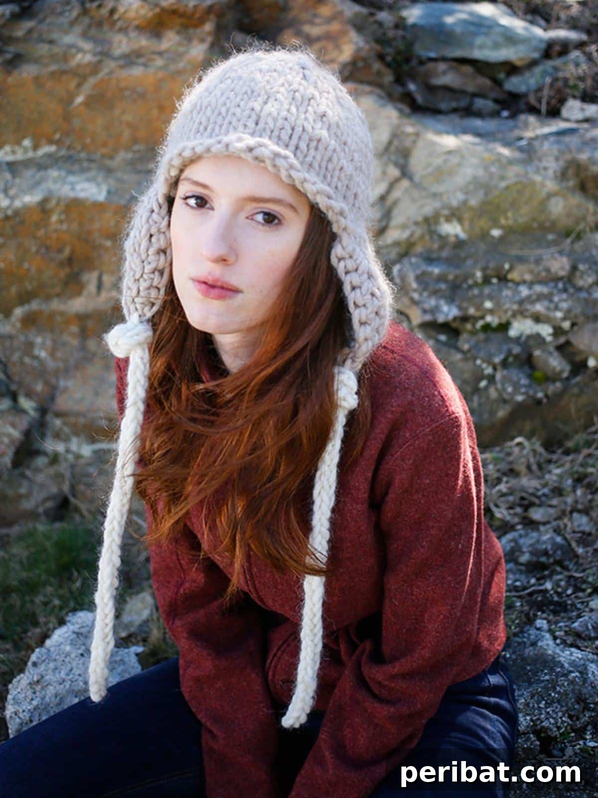 32 Cozy Ear Flap Hat Knitting Designs 29 The Zoya Knit Hat, a free pattern featuring contrasting color ties for a playful and stylish look.