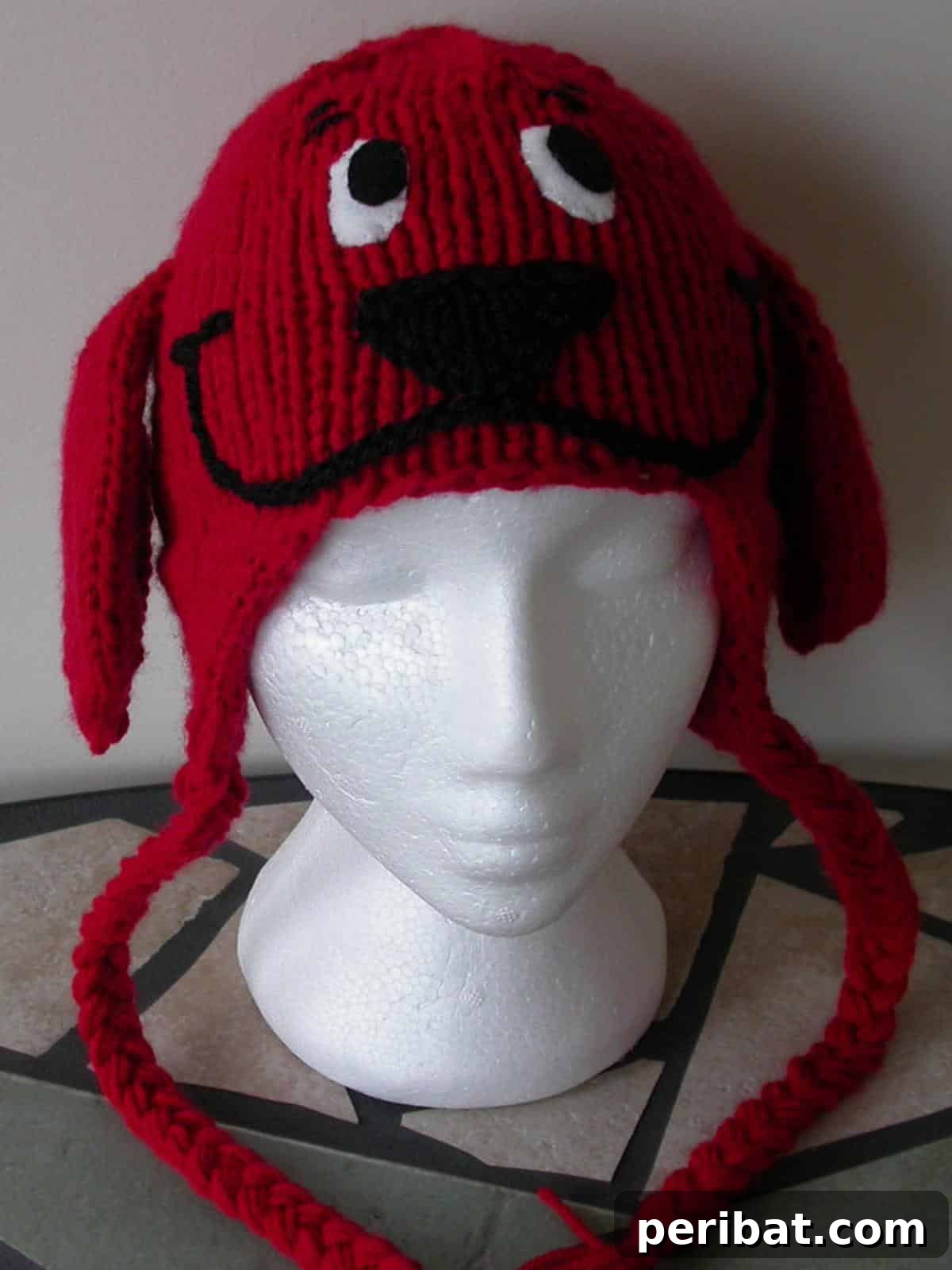 32 Cozy Ear Flap Hat Knitting Designs 5 An adorable red earflap hat for babies, inspired by a big red dog character, featuring cute ear details.