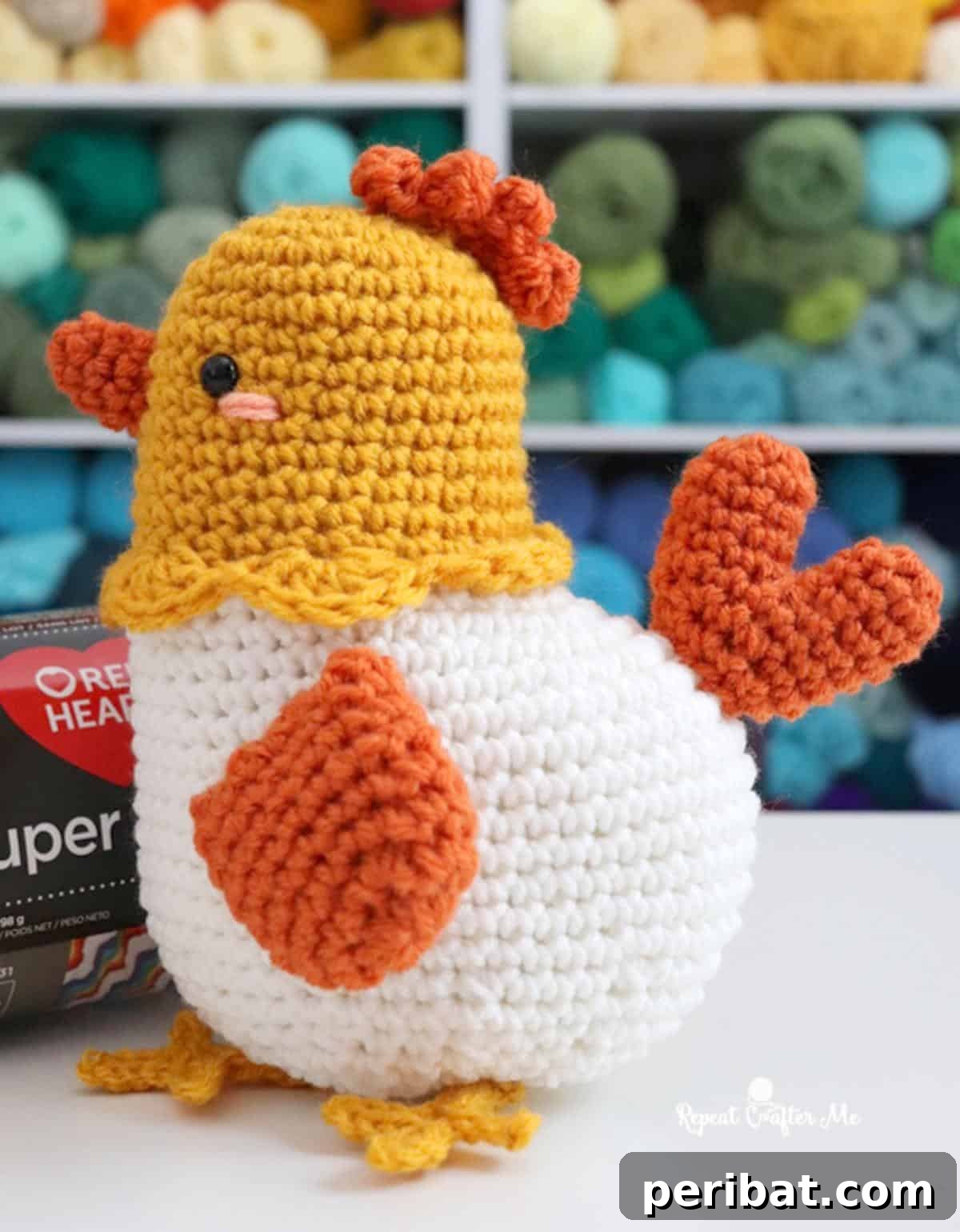 An adorable amigurumi crochet chicken with colorful details.
